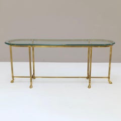 brass console table with profiled glass & brass hoofs La Barge
