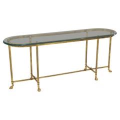 brass console table with profiled glass & brass hoofs La Barge