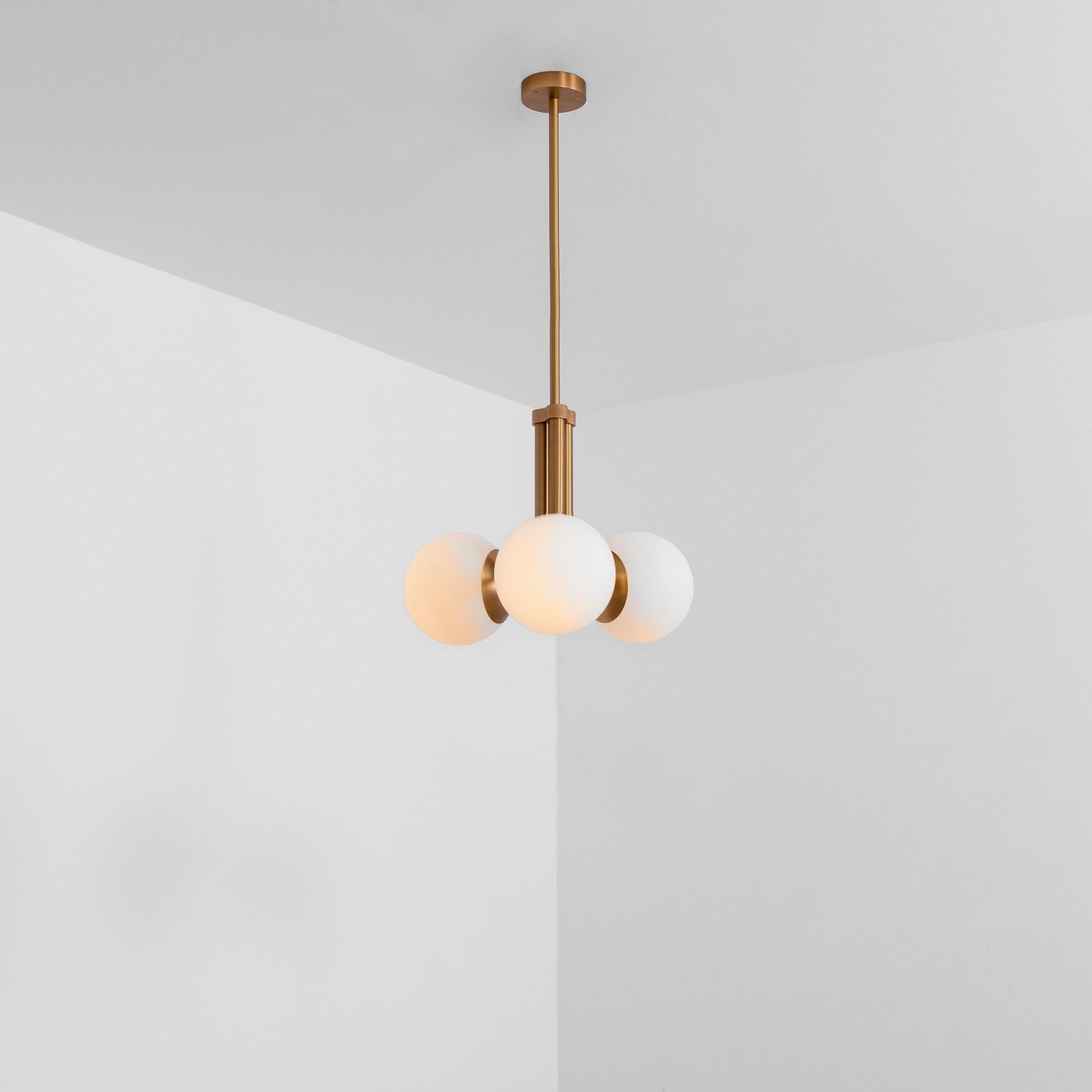 Tubular SM Brass Pendant Light 3 by Schwung
Dimensions: W 48 x D 48 x H 103 cm
Materials: Brass, frosted glass

Finishes available: Black gunmetal, polished nickel, brass
Other sizes available

 Schwung is a german word, and loosely defined, means
