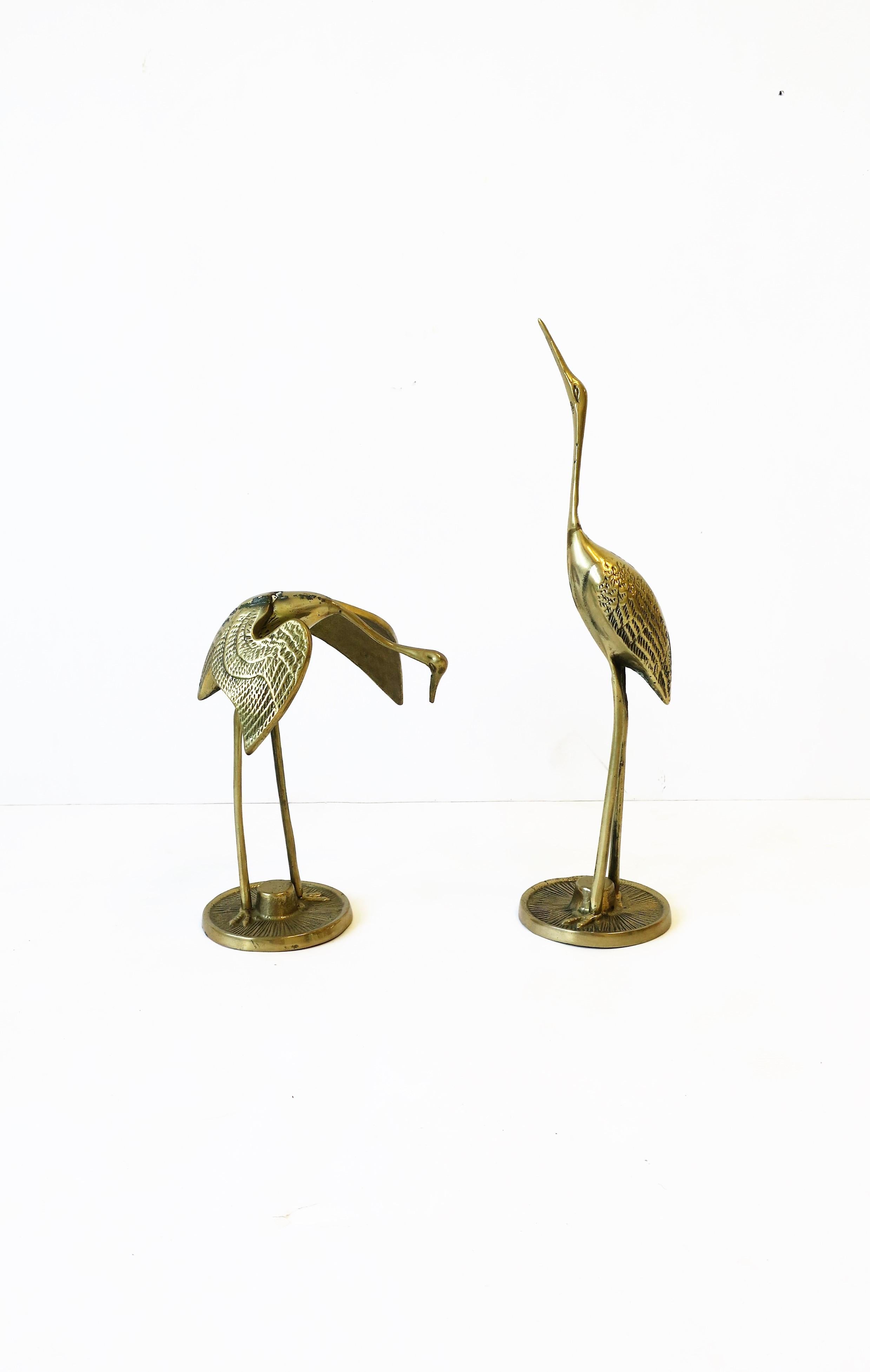 A pair/set of brass crane bird sculptures decorative objects, circa 1970s. 

Measurements, first image, L to R: 
5.25