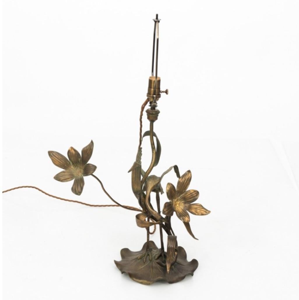 Circa 1910 Brass lamp featuring a crane and flower base. Recently rewired with new shade.