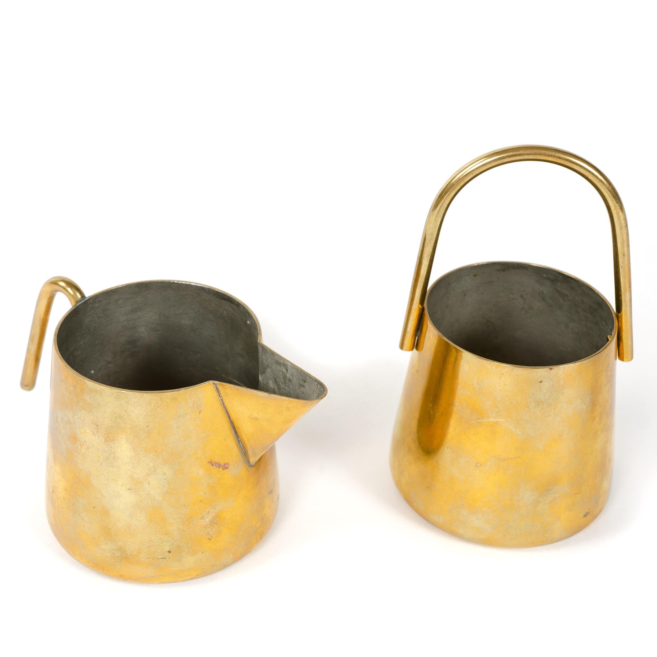 A Mid-Century Modern brass cream and sugar set designed by Carl Aubock. Designed and made in Austria, 1950s.