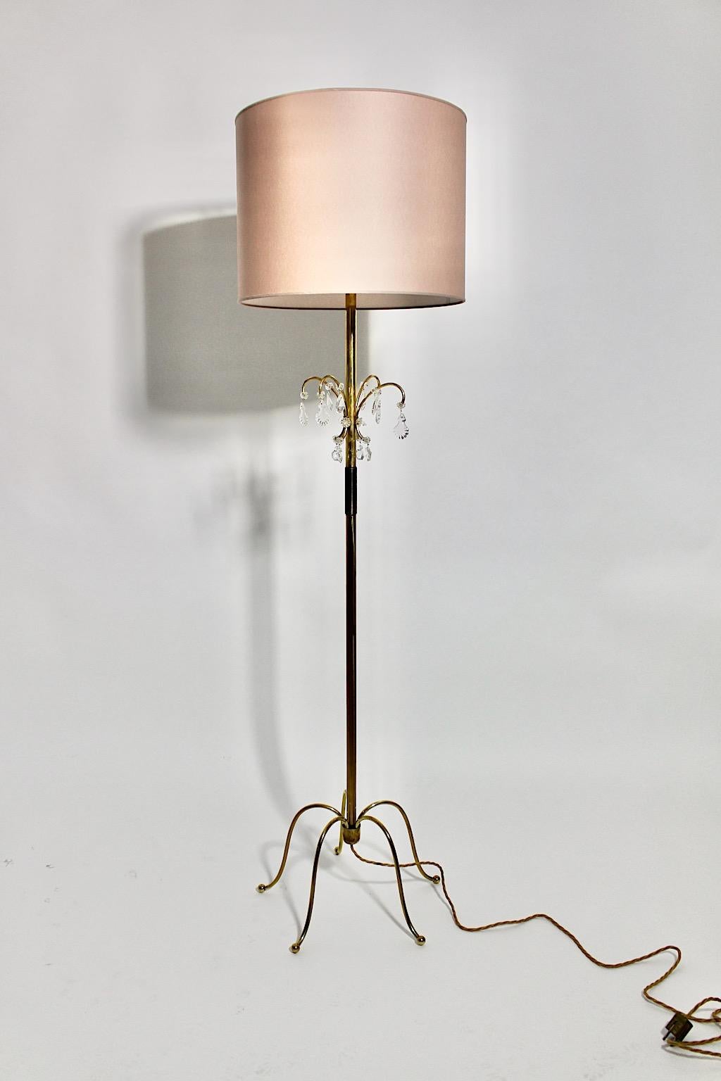A brass crystal glass vintage Mid-Century Modern floor lamp, which was designed and executed by J.&L. Lobmeyr, 1950, Vienna.
The beautiful and delicate brass floor lamp with cut crystal glass elements shows a renewed paper lamp shade in a cute soft