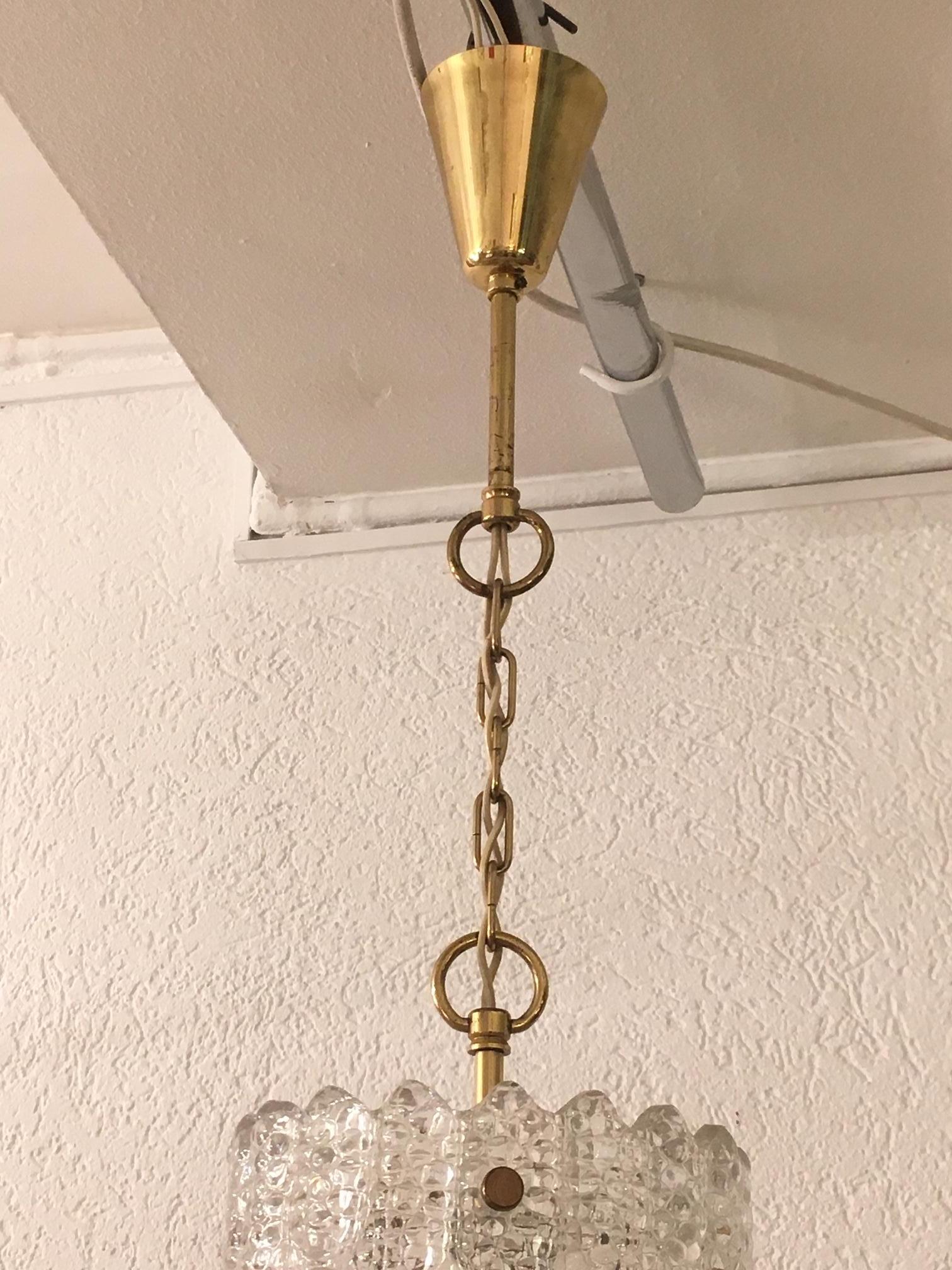Brass and crystal pendant lamp by Carl Fagerlund produced by Orrefors, Sweden, circa 1950
Perfect condition
Measures: 18cm diameter, total height (with chain) 70cm.
 