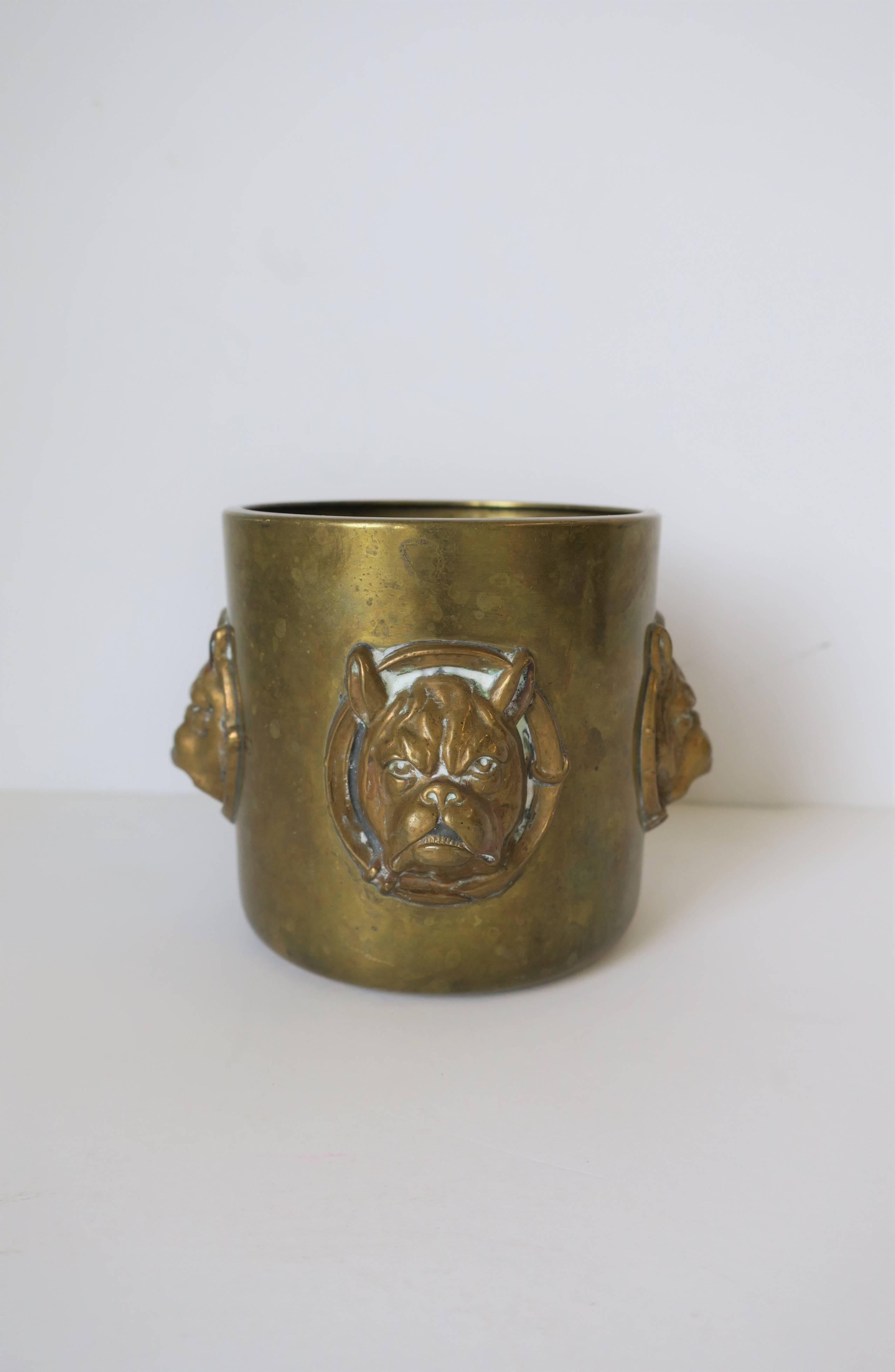 A vintage brass cup or desk writing utensil holder with bulldog face sculpture motif. Great detail in bulldog's face as show in images. There are four bulldog face sculptures around cup as show in images. 

Cup measures: 3 in height x 3 in