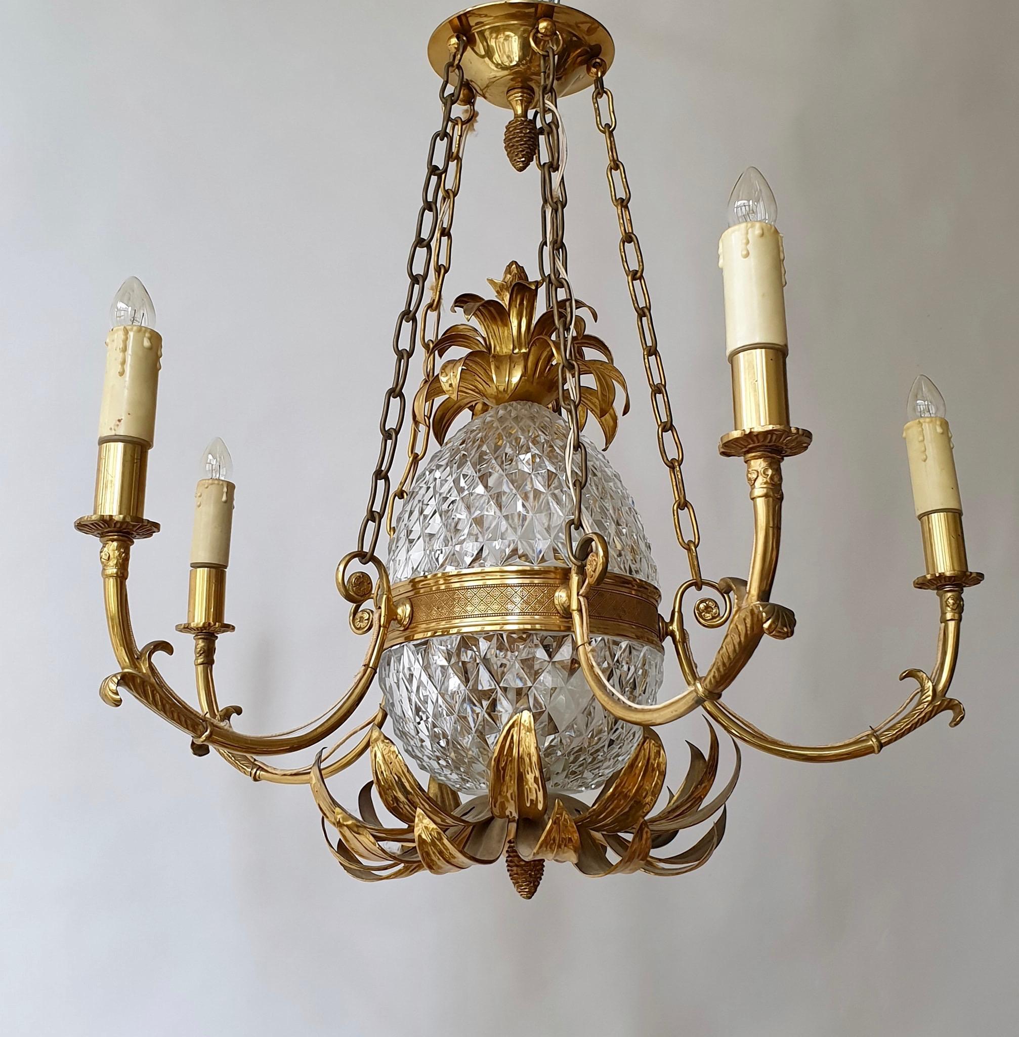 Gilt brass and cut crystal pineapple chandelier made in France, circa 1960-1970. It needs 7 x E14 standard screw bulbs to illuminate. After years this gorgeous chandelier stays in a very good to excellent original vintage condition with minor wear