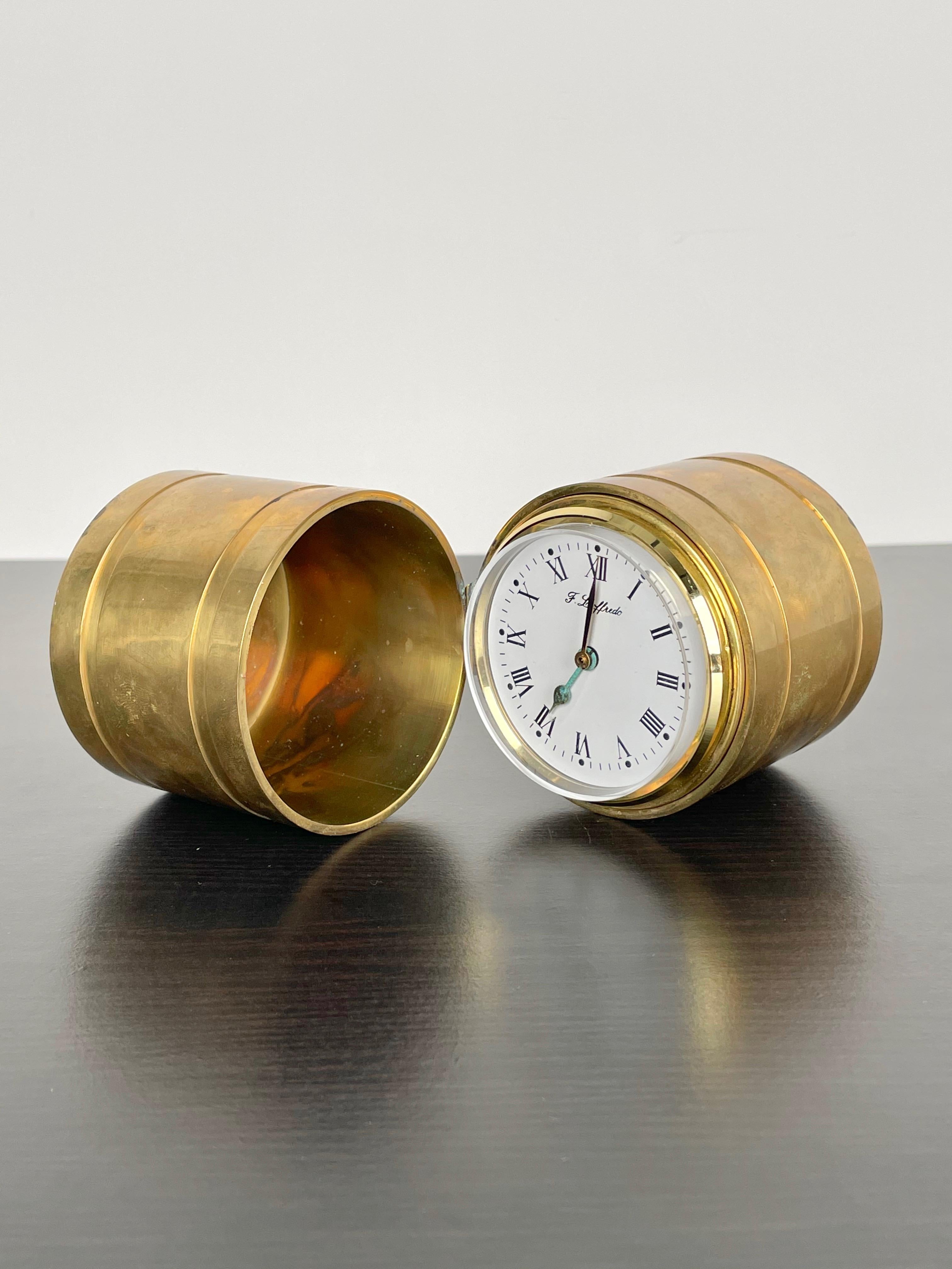 Cylindric table and desk clock in brass by the Italian designer Ferdinando Loffredo made in Italy in the 1970s. The clock is not functioning, it is sold as a decorative object. 
His signature is engraved on the bottom as shown in the pictures.

 