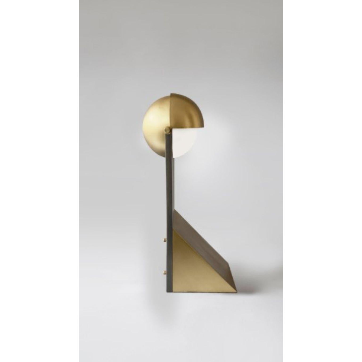 Brass Dance of Geometry table lamp by Square in Circle
Dimensions: H48 x W14 x D18 cm
Materials: Brushed brass, Brushe grey metal

Inspired by costumes from The Bauhaus Ballet, this triadic table lamp design utilizes the three essential