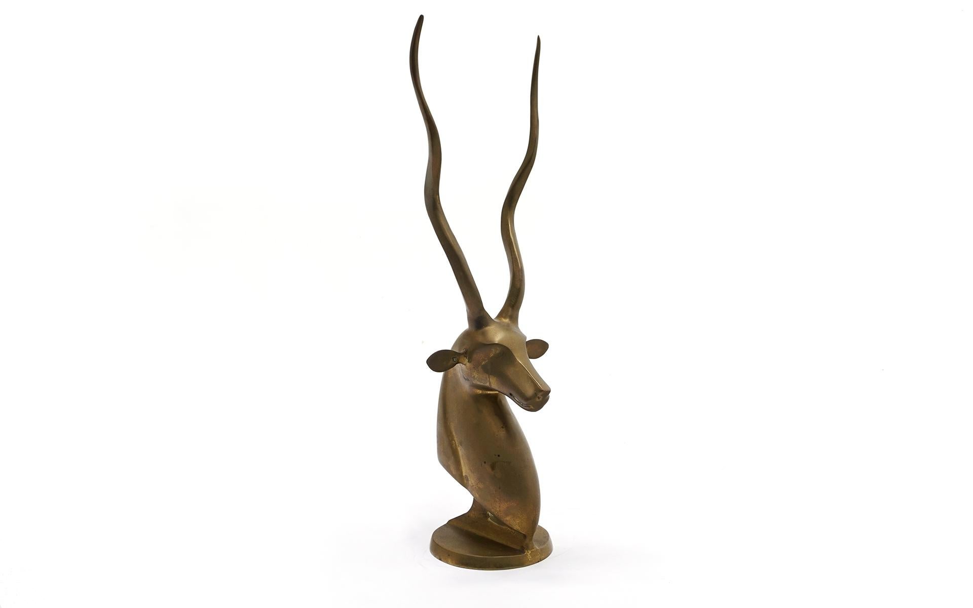 Twenty one inch tall stylized deer bust with antlers. The brass has a beautiful natural patina.