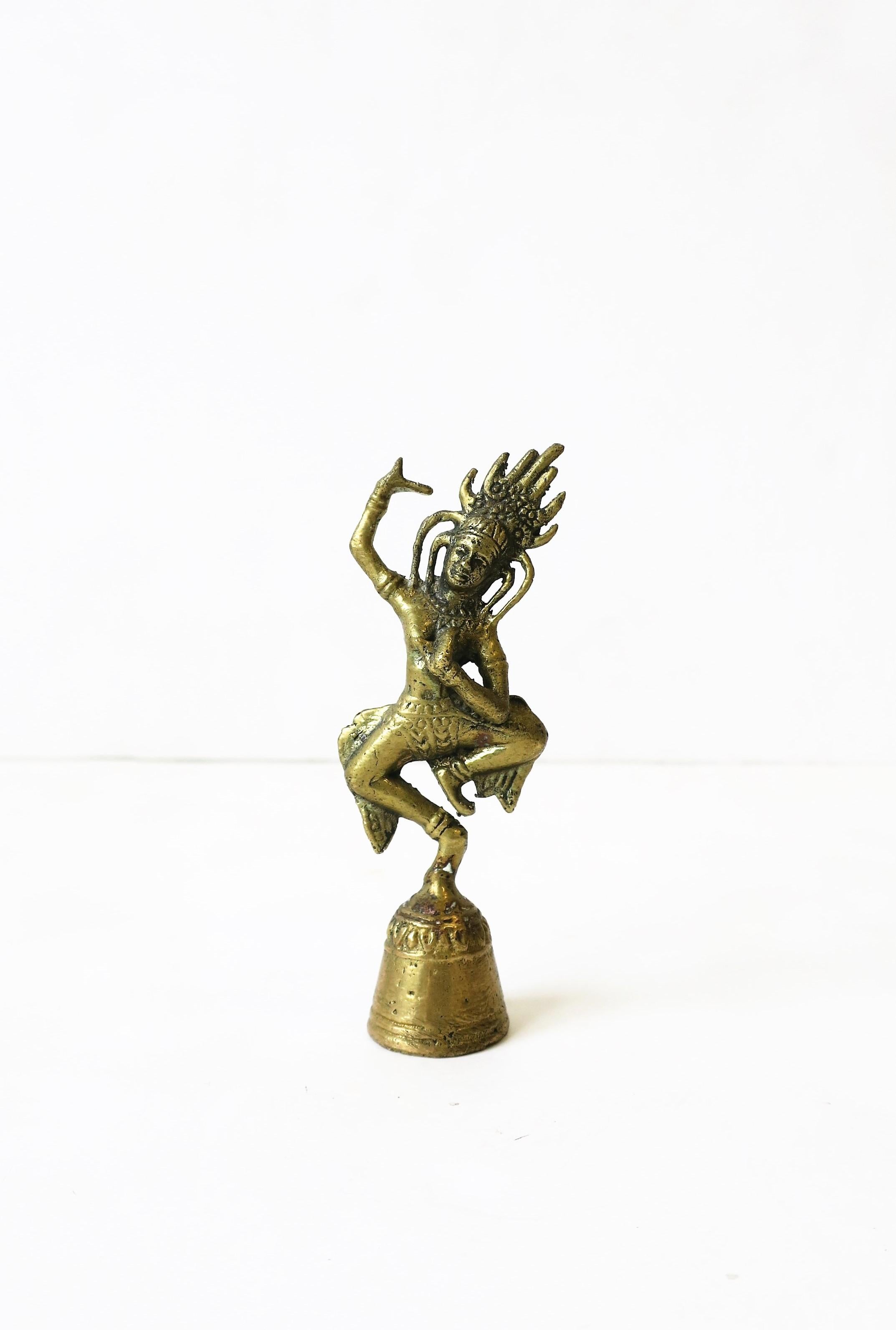 A brass Aspara bell sculpture piece, circa 20th century, Asia. 