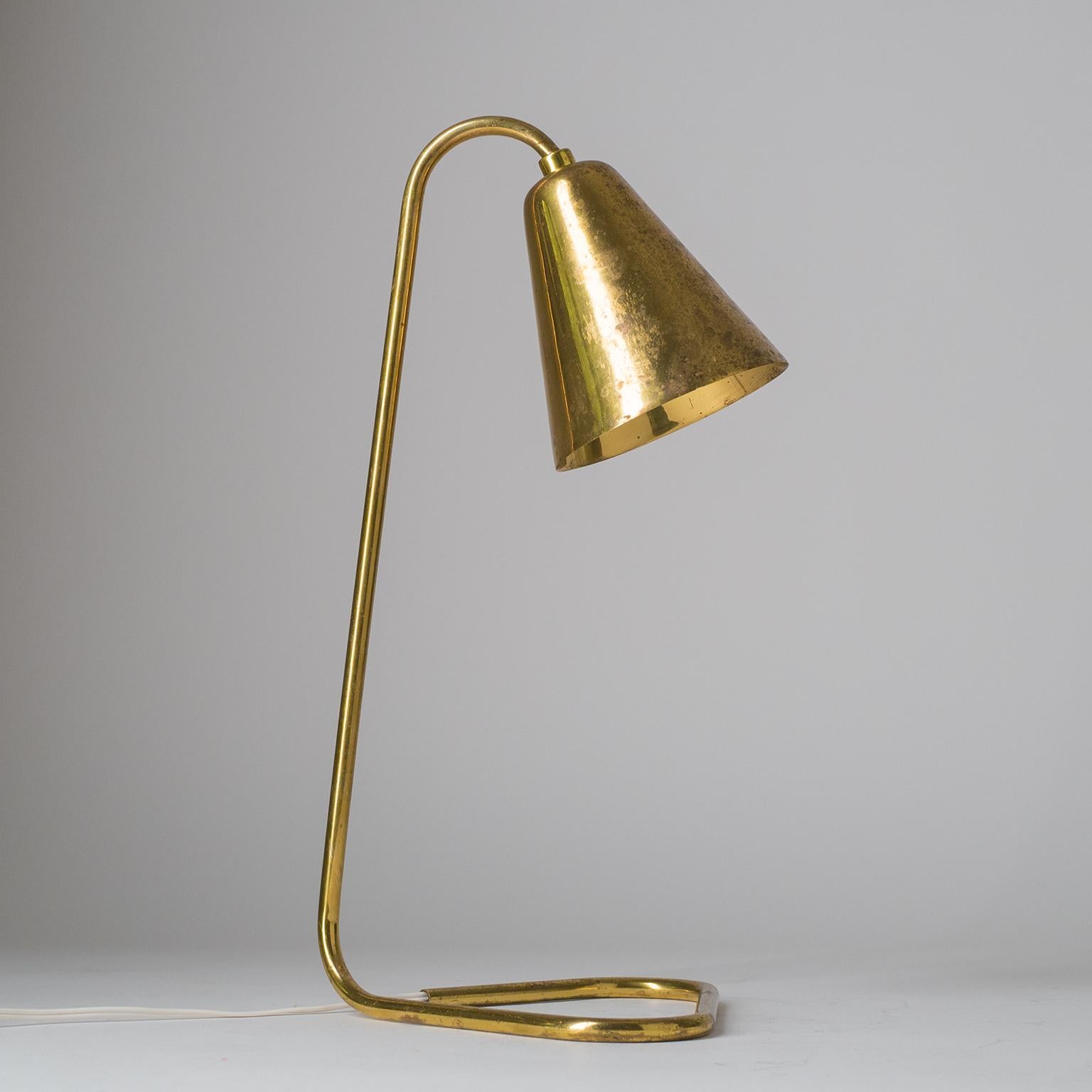 Rare brass table/desk lamp from the 1950s. One brass E14 socket.