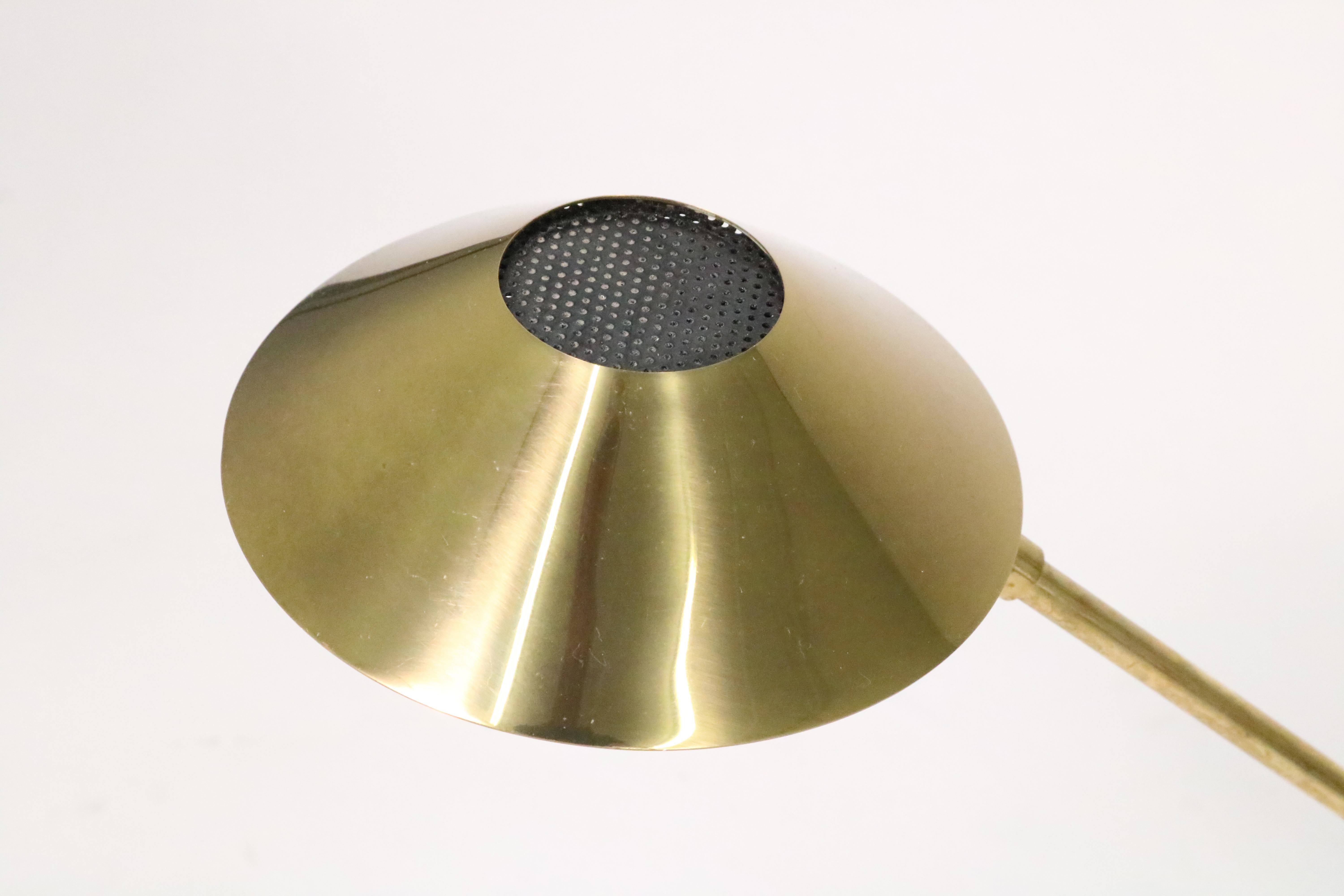 A handsome mid-century brass desk lamp. Shade rotates slightly left or right. One high-intensity bulb.