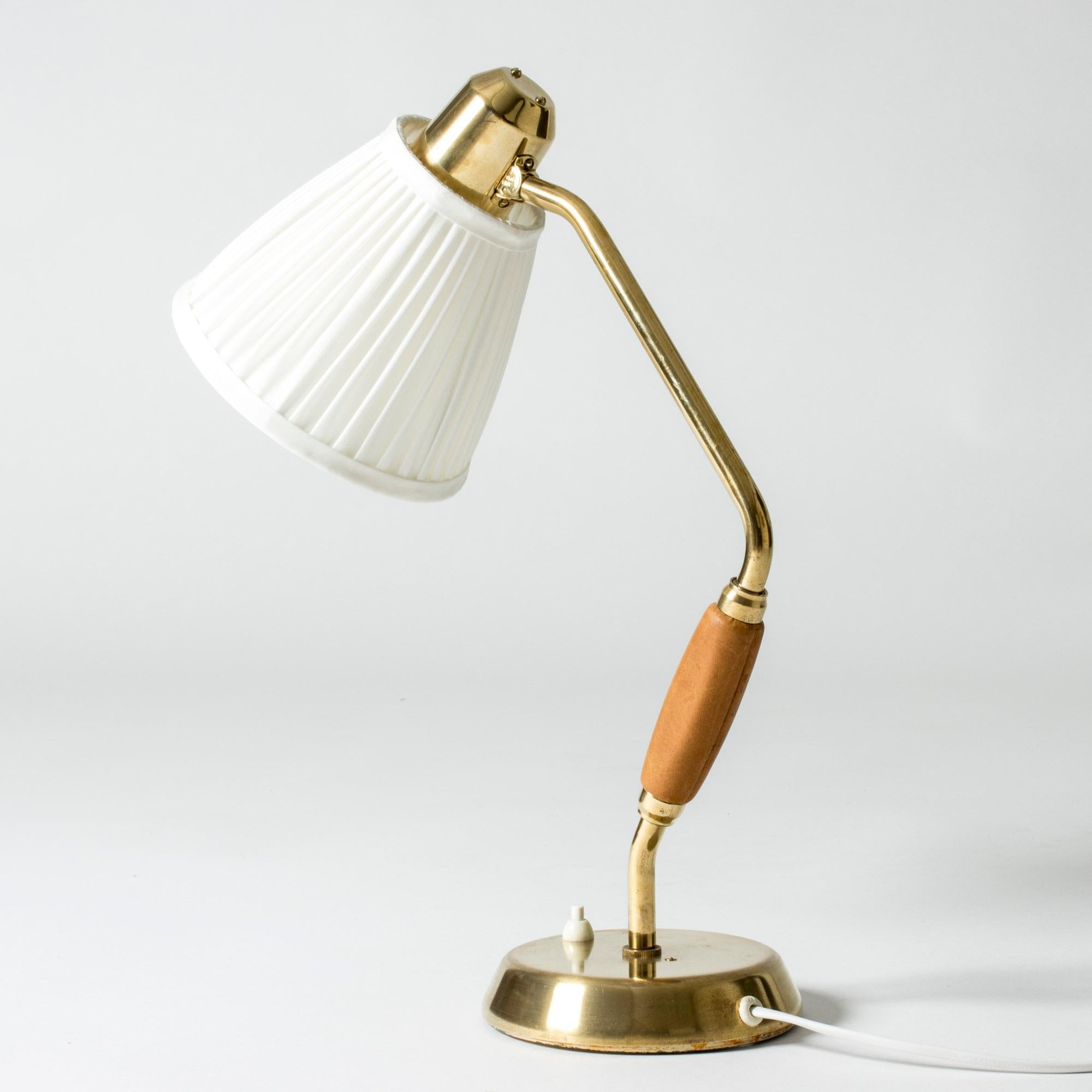 Lovely desk lamp from ASEA, made from brass with a leather dressed handle. Neat, pleated lamp shade.