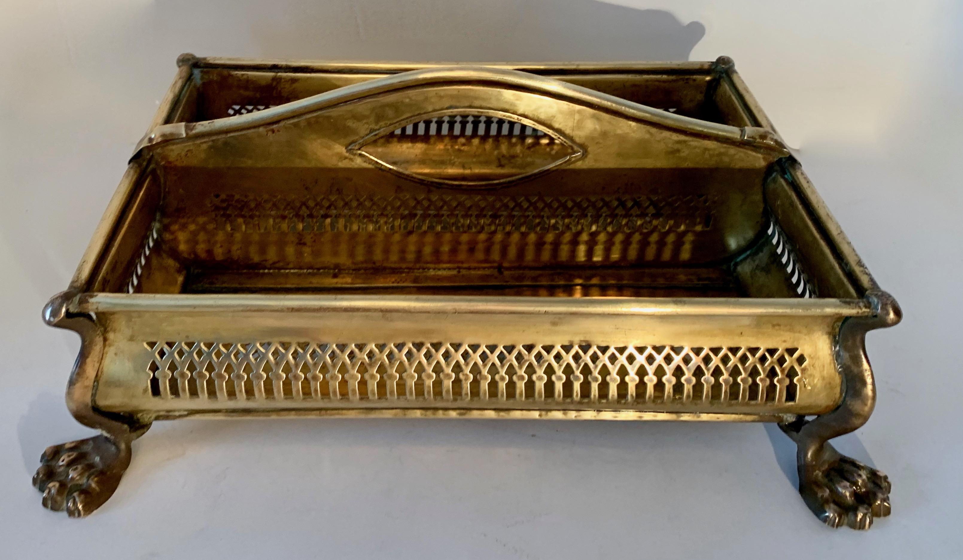 A handsome vintage brass, two-compartment caddy well suited for the vanity, food display, mail or even plants... a wonderfully designed piece sporting lions feet and intricately cut sides for great eye appeal. A wonderful desk accessory or catering