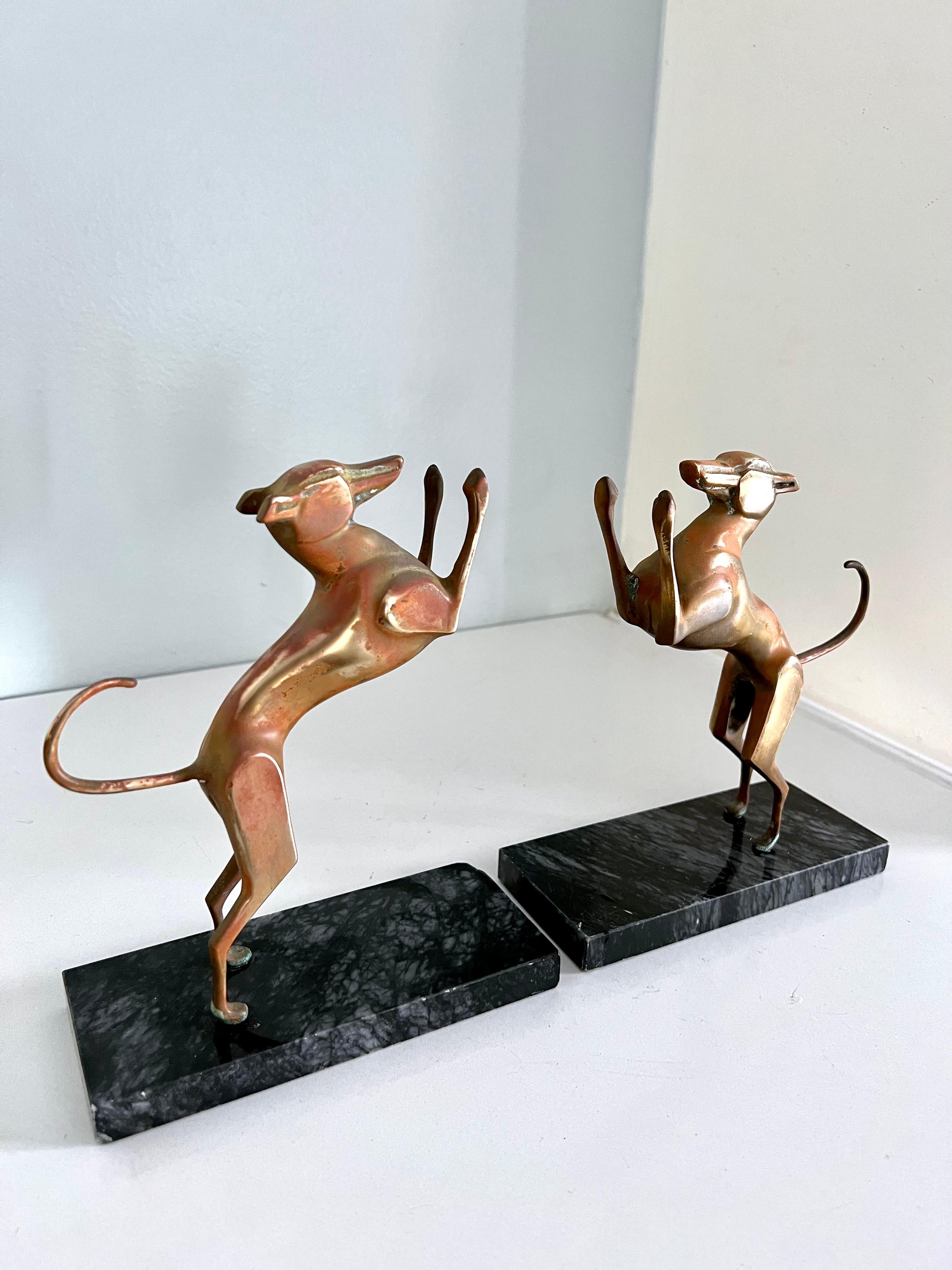 A pair of patinated guard dogs for your books. Marble base steadies the books, so dogs appear to be jumping, rather than pressing against the books. A compliment to any bookshelf. 

 