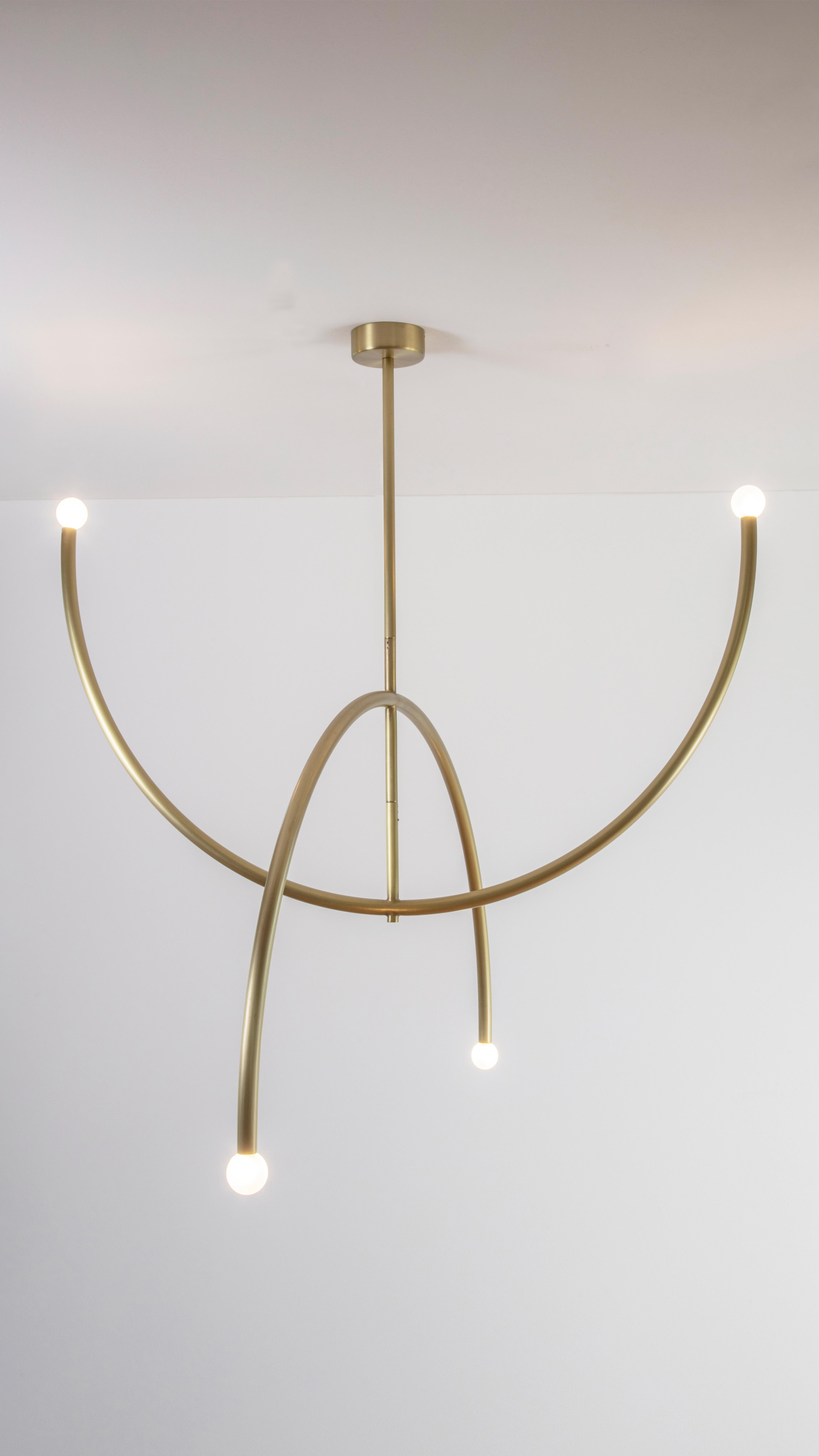 Brass Double Arch Pendant Light by Square in Circle
Dimensions: W115 x H120 x D115 cm
Materials: Brushed brass, white frosted glass globe

This minimal brushed brass pendant light is formed from two arches. Both arches have opaque glass globes at