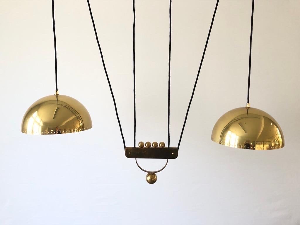 Brass Double shade XXL adjustable Counterweight Pendant Lamp by Domicil Möbel, 1970s, Germany

Lampshade is in very good vintage condition.

This lamp works with E27 light bulbs. 
Wired and suitable to use with 220V and 110V for all