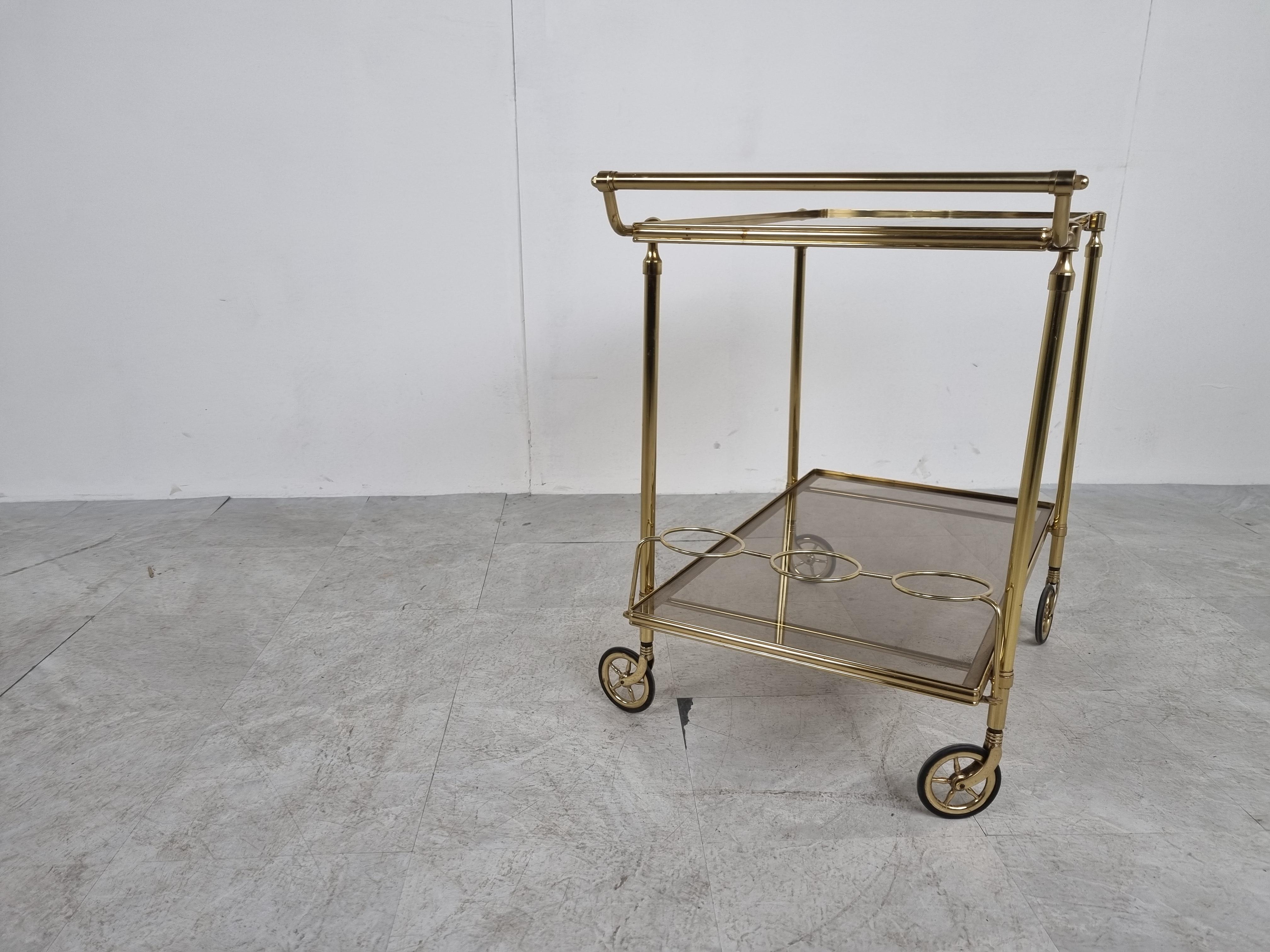 Elegant mid century brass serving trolley with smoked glass.

1960s- France

Good condition with normal age related wear

Dimensions:

Height: 66cm/25.98