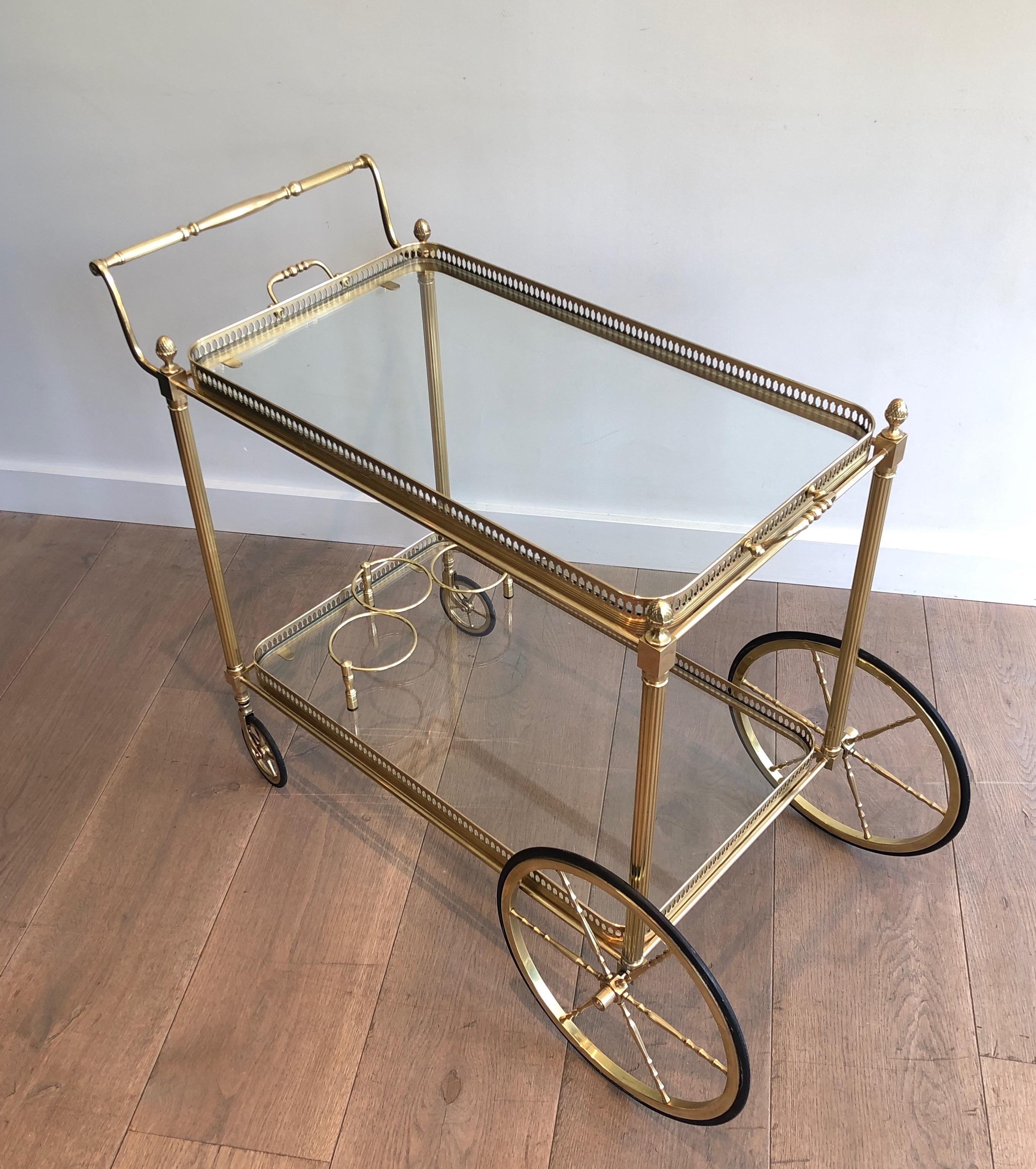 This neoclassical style drinks trolley is made of brass with two removable trays. This is a fine work with nice finely chiseled details. This is a French work by Maison Jansen. Circa 1940