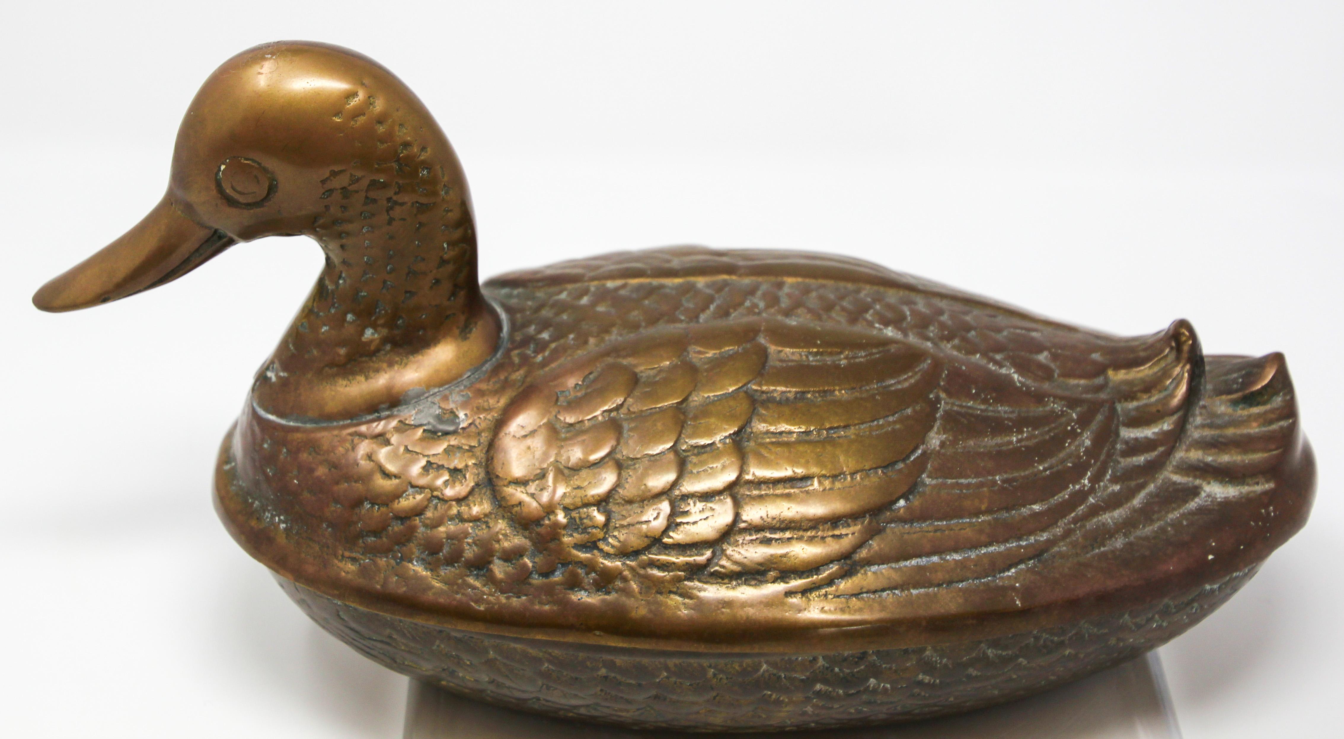 Handcrafted decorative vintage collectible brass nut duck shape trinket box.
Beautiful handcrafted large cast brass bird form box with lid.
Vintage two-piece solid brass figural duck trinket box.
Delicately and intricately hand-hammered probably