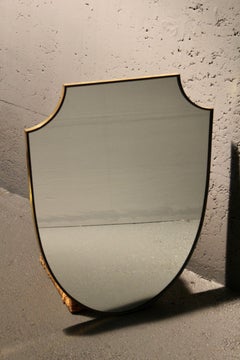 Brass écusson wall mirror
