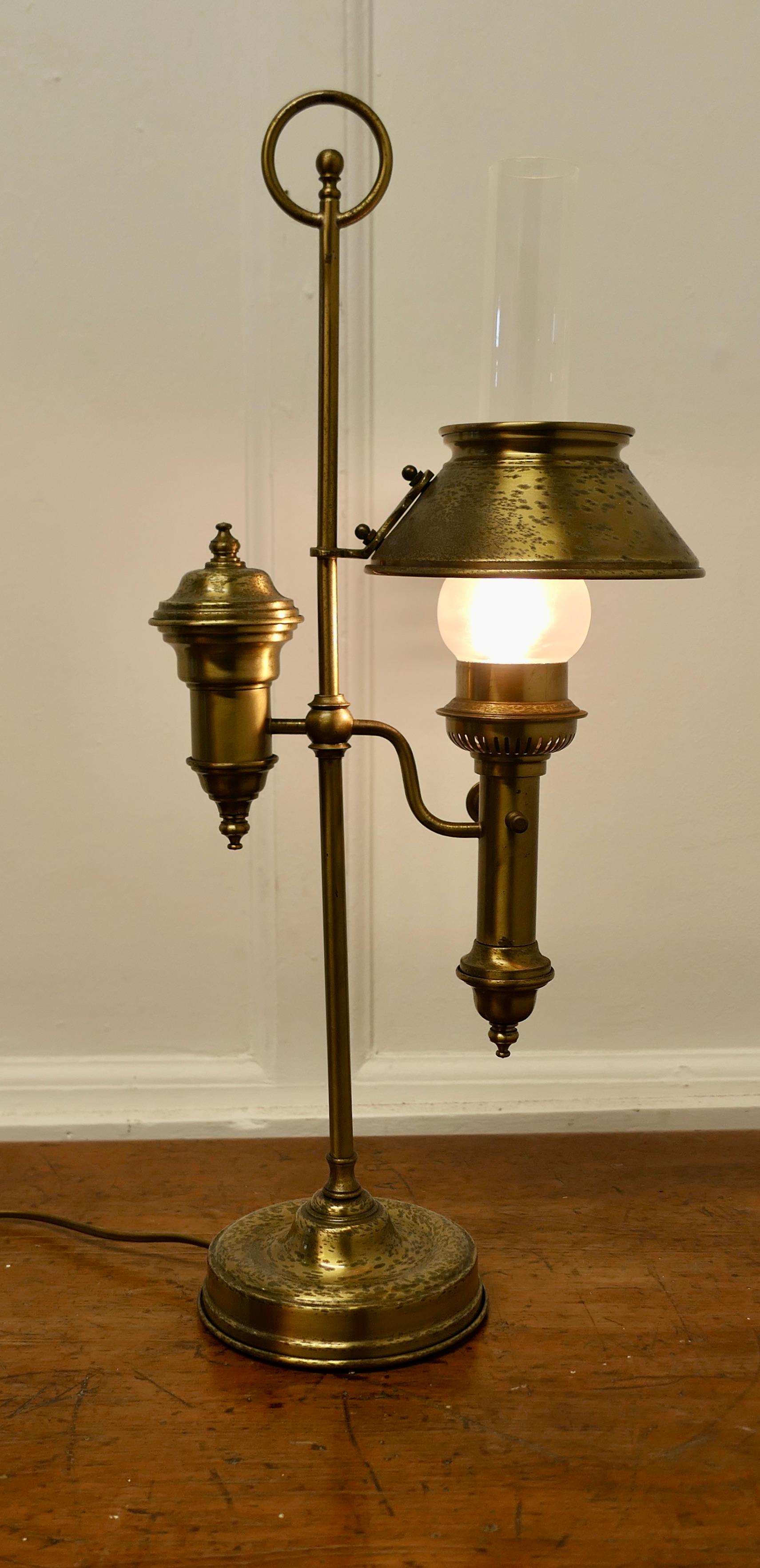Brass Electrified Table Lamp 

This is a super looking piece, it has been copied from the design of an old oil  lamp with an oil reservoir with glass chimney and brass shade
The lamp is a beautiful and elegant piece with a nod to a past classic, it
