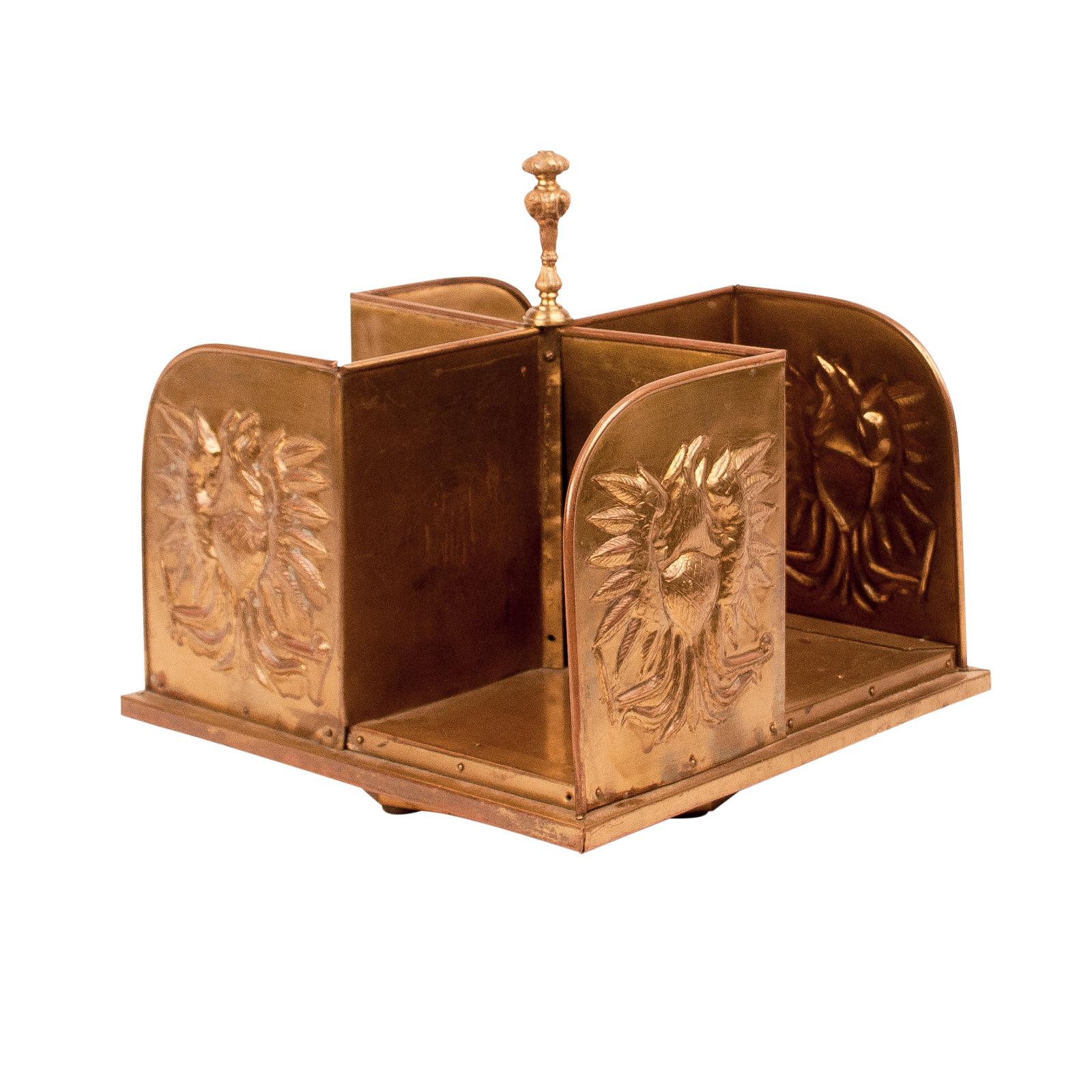 A swivel brass book caddy embossed with an eagle, circa 1900.