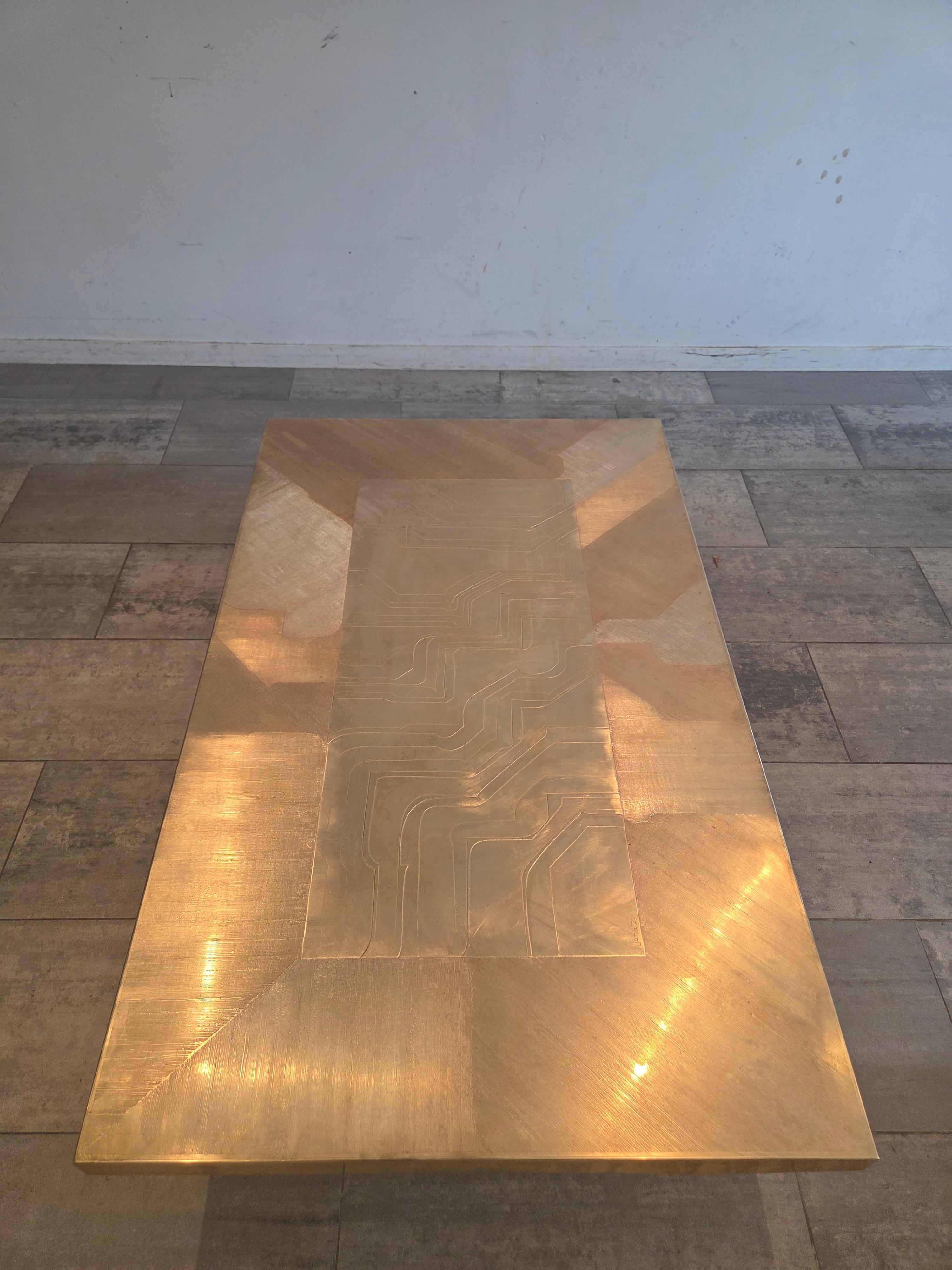 Elevate your interior with this exceptional brass etched table, a rare piece that embodies both artistry and refinement. The tabletop showcases intricate, hand-etched motifs in solid brass, each detail reflecting the precision and timeless skill of