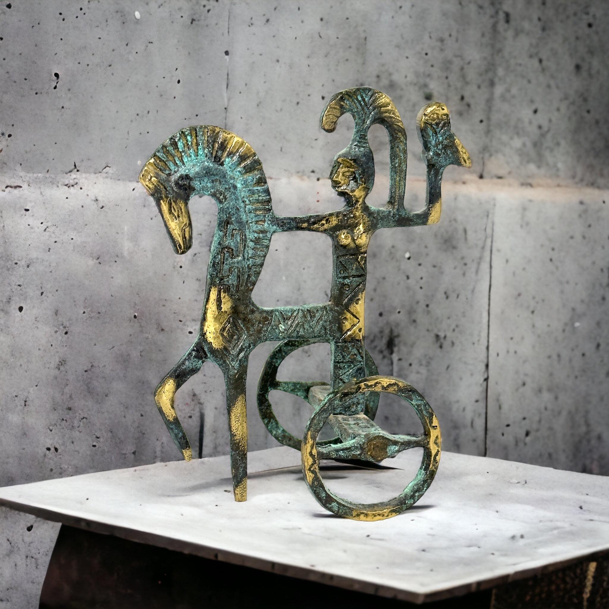 This is a bronze sculpture, in the style of the antique statues and figures of the Etruscans is a gorgeous interior furnishing item. it is an incredibly stylized Etruscan Chariot and has a patina finish. Greece-made and great for any Mid-Century