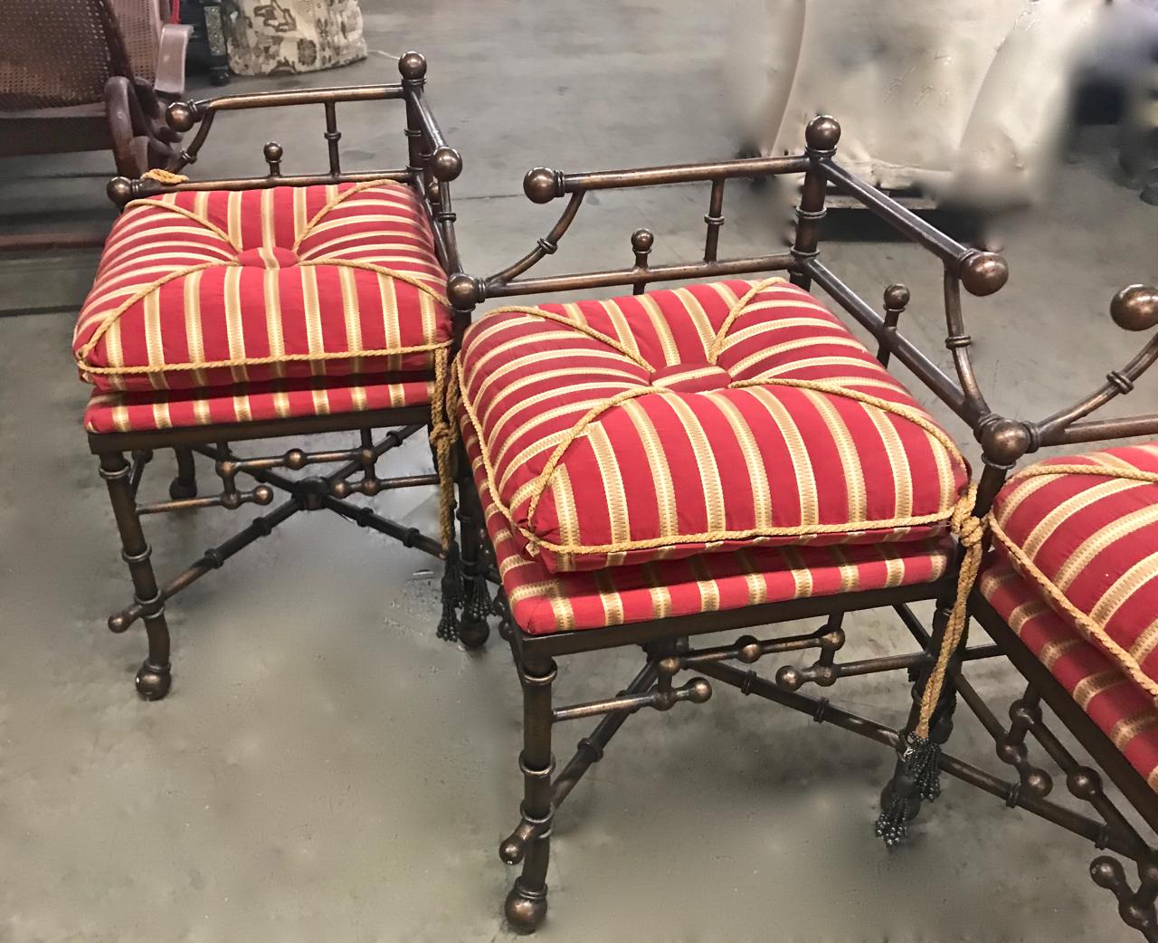 This is a unique 20th century triple seat brass faux bamboo bench that has been beautifully upholstered in a silk and tassels. Both the bench and upholstery are in excellent condition. This multipurpose bench could be placed at the foot of a bed, in