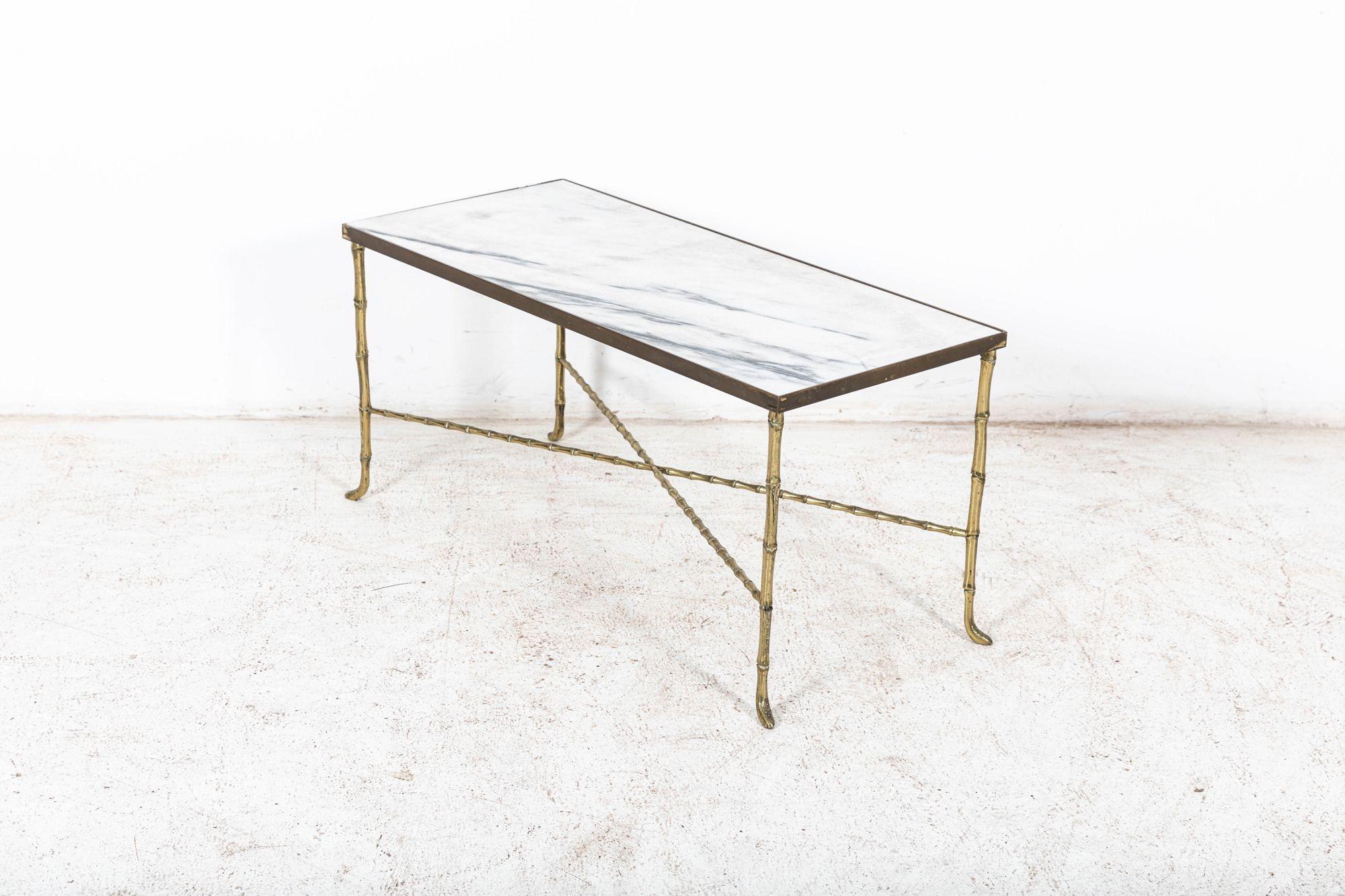 Circa 1940

Brass Faux bamboo coffee table. Decorative faux bamboo coffee table attributed to Maison Bagues with white marble top.

Measures: W 93 x D 42 x H 45 cm.

   