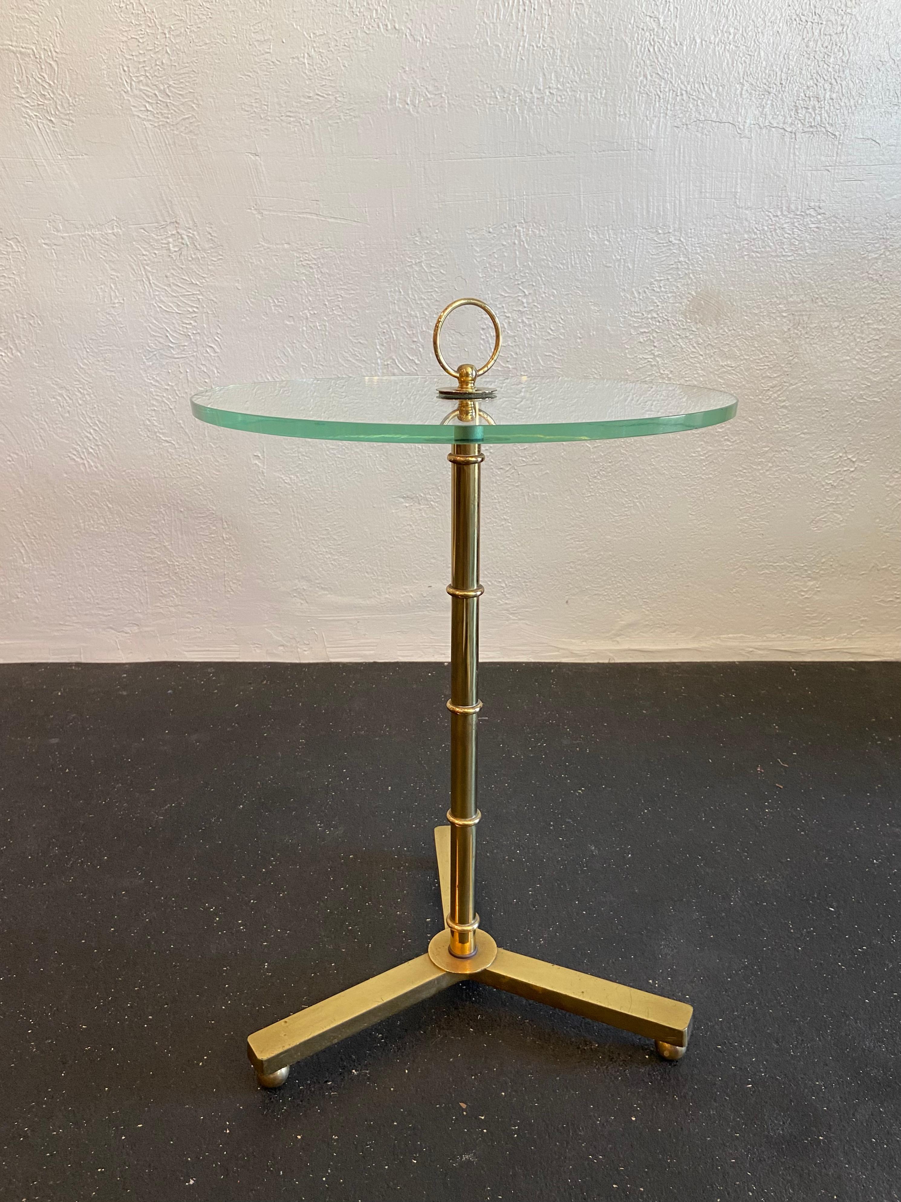 Brass faux bamboo drink table. Patina to the brass frame and surface wear to the glass, including one minor chip to the bottom surface edge of glass (please refer to photos). Please note that the glass height is 20.5” while the overall height of the
