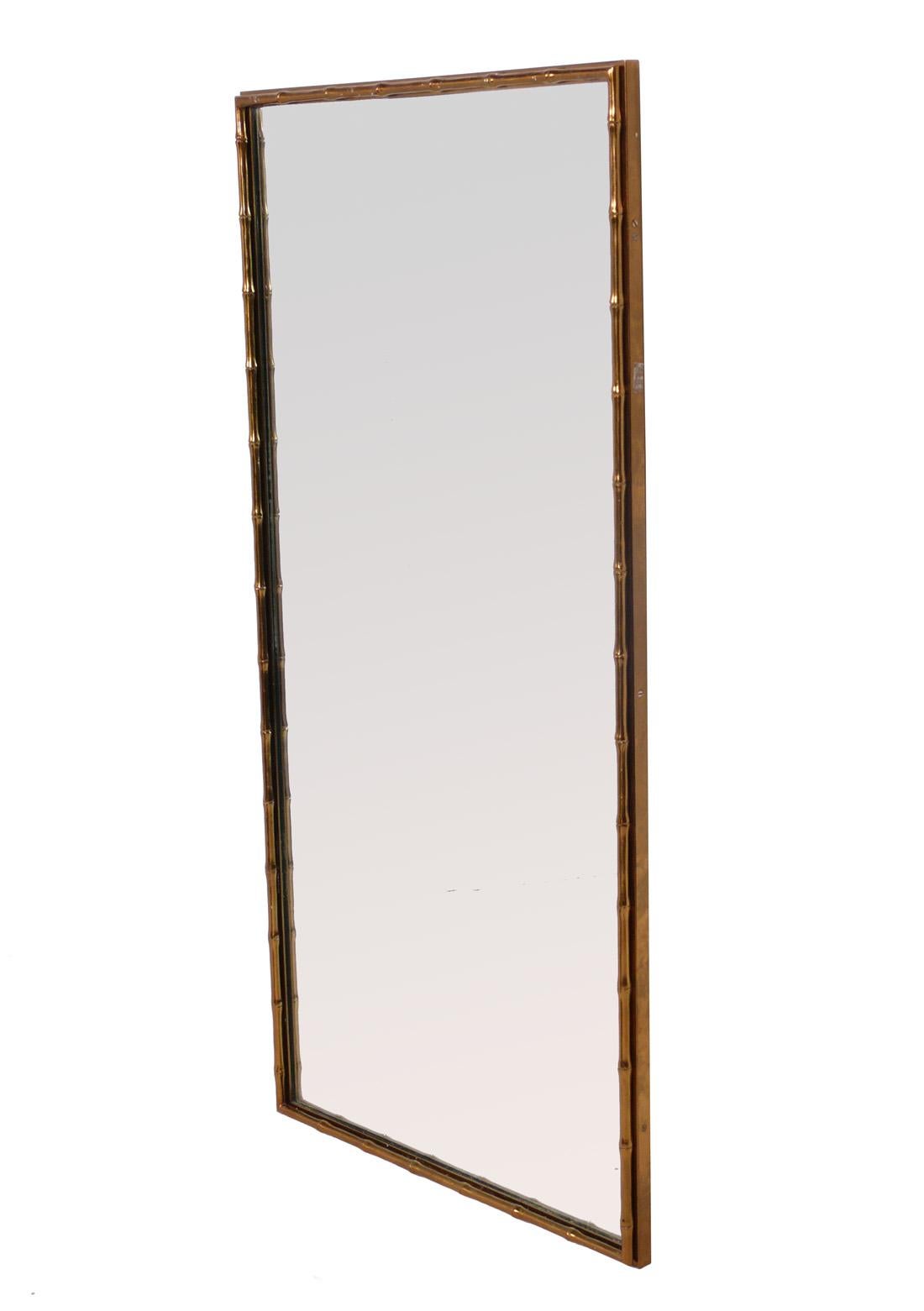 Glamorous brass faux bamboo mirror, American, circa 1960s. It measures an impressive 48