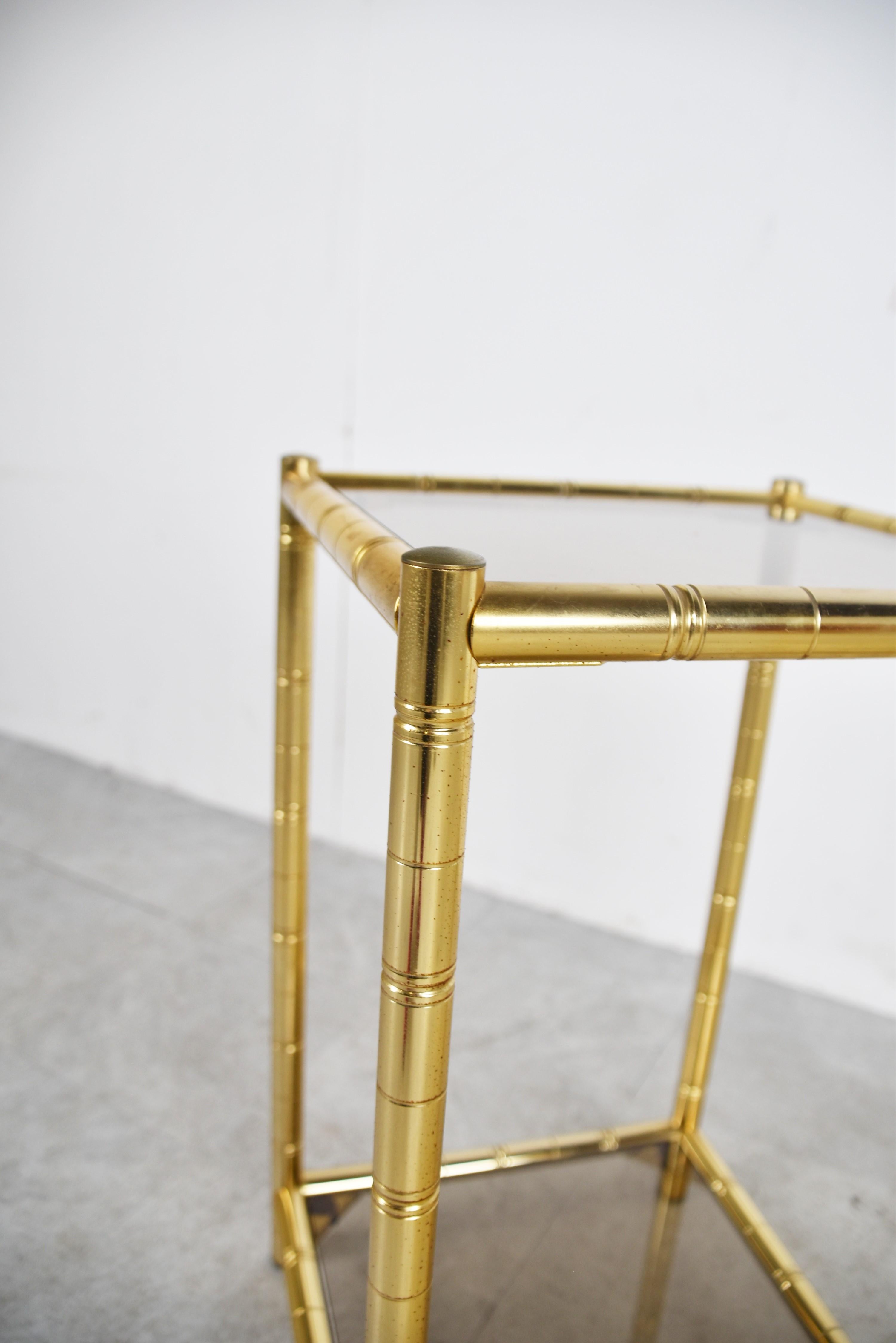 
Mid century brass faux bamboo two tier side table.

This elegant side table is ideal to mix with modern day interiors to create a lovely contrast.

1970s - France

Dimensions:
Height: 64cm/25.19