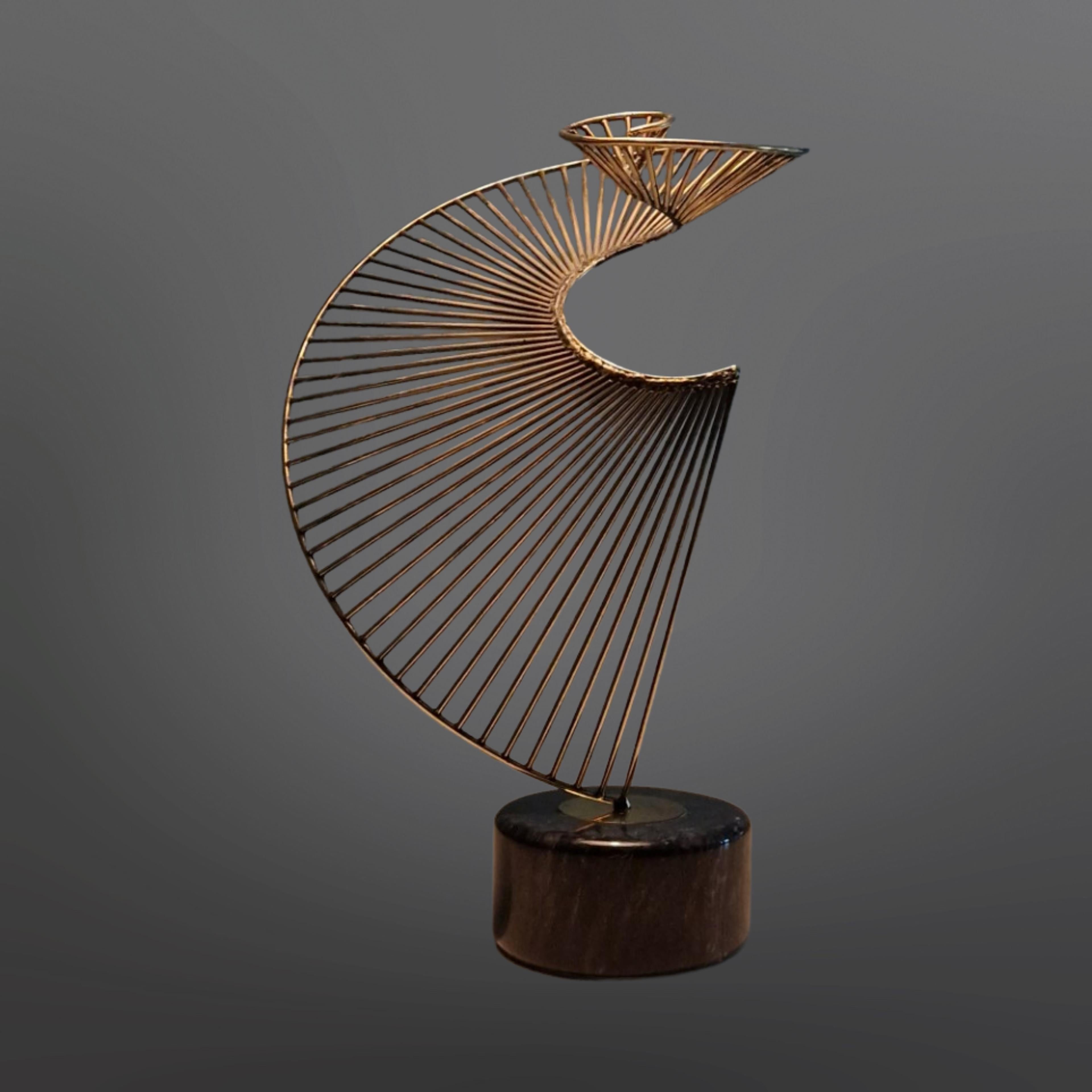 Brass spiraling artwork on a black marble base. Attributed to Curtis Jere 1970s. Highly decorative piece of art that also makes a beautiful sound by 