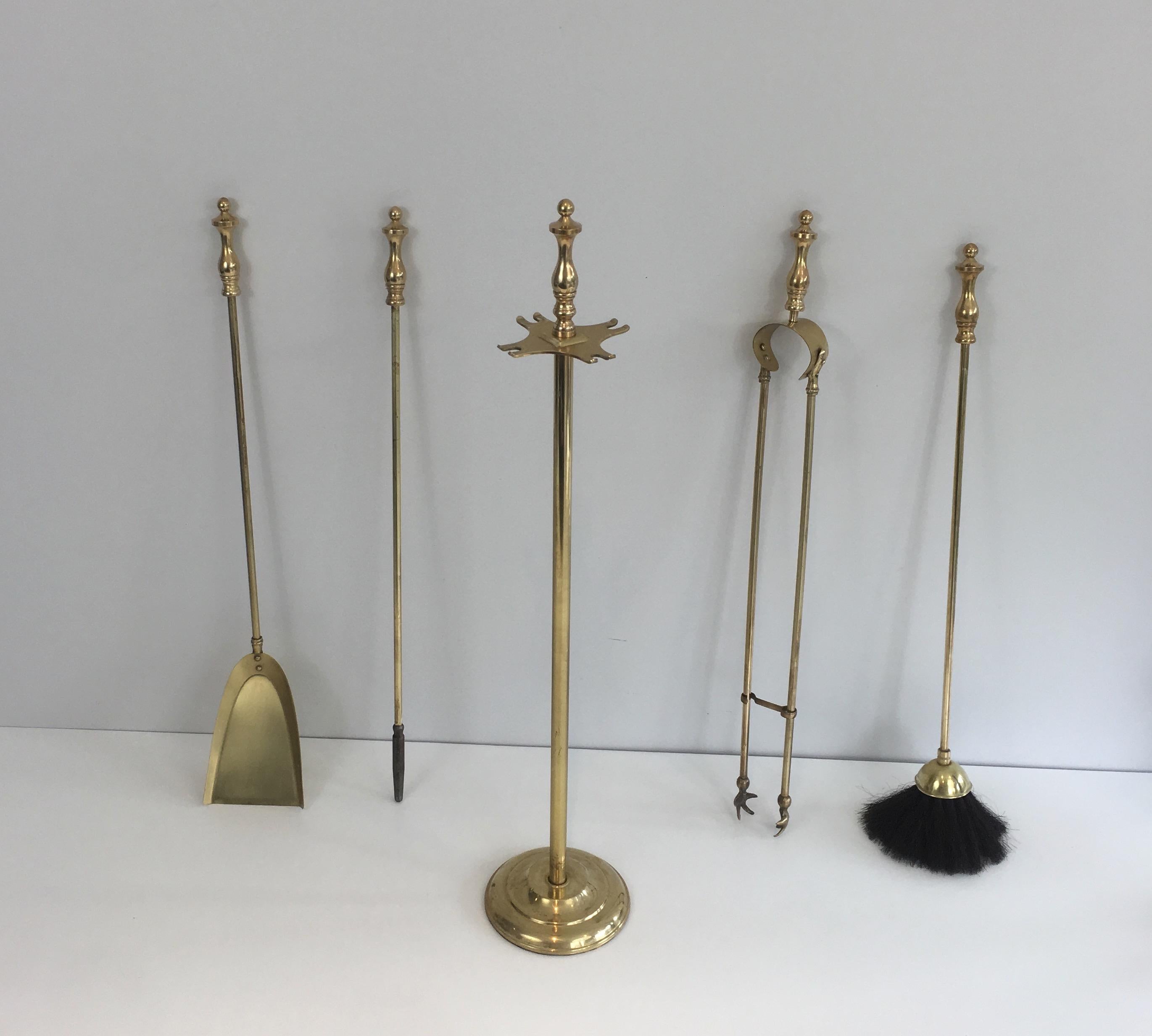 These elegant neoclassical style fire place tools are all made of brass. This is fine French work, circa 1970.