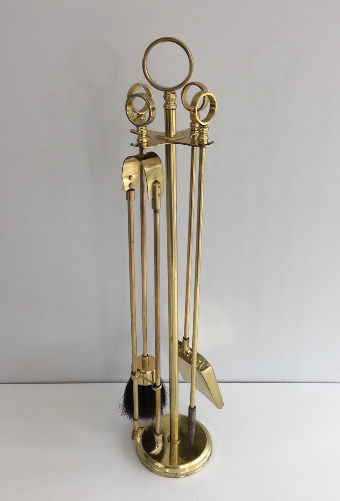 These fire place tools on stand are made of gilt brass. The particularity of this model is that handles as are made of circles. The gilt has been used a little bit by time as show on the pictures. They are French, circa 1970.