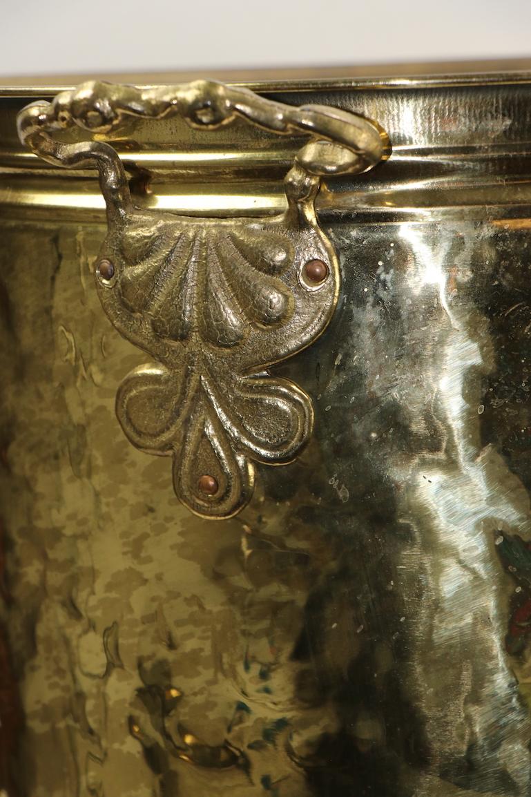 Decorative embossed footed brass bucket originally designed to hold kindling and small wood for the fireplace, but also suitable for other applications, be creative with this charming item. Brass body with cast brass feet and decorative applied cast