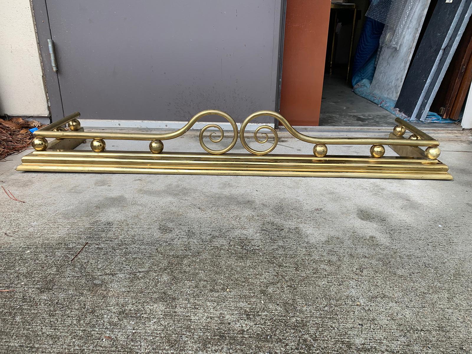 Brass fireplace fender, circa 1900.