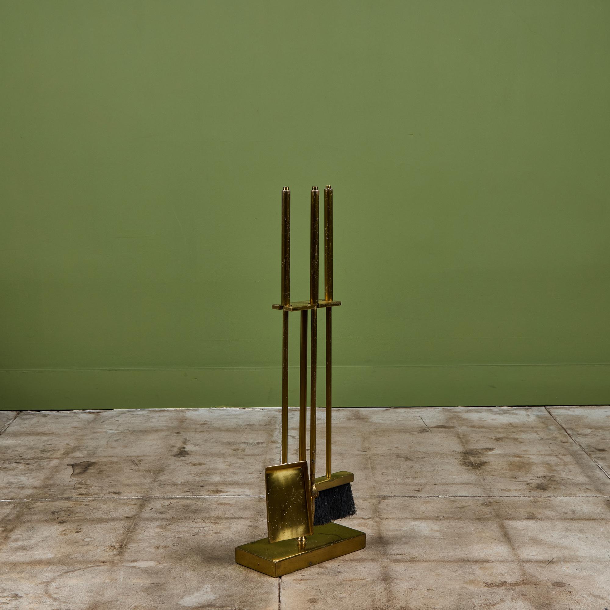 Three piece set of brass fireplace tools with stand. The set features three tools, shovel, broom and poker, all set on a matching brass stand. A minimalist, but eye catching addition to your fireplace.

Dimensions
11.5