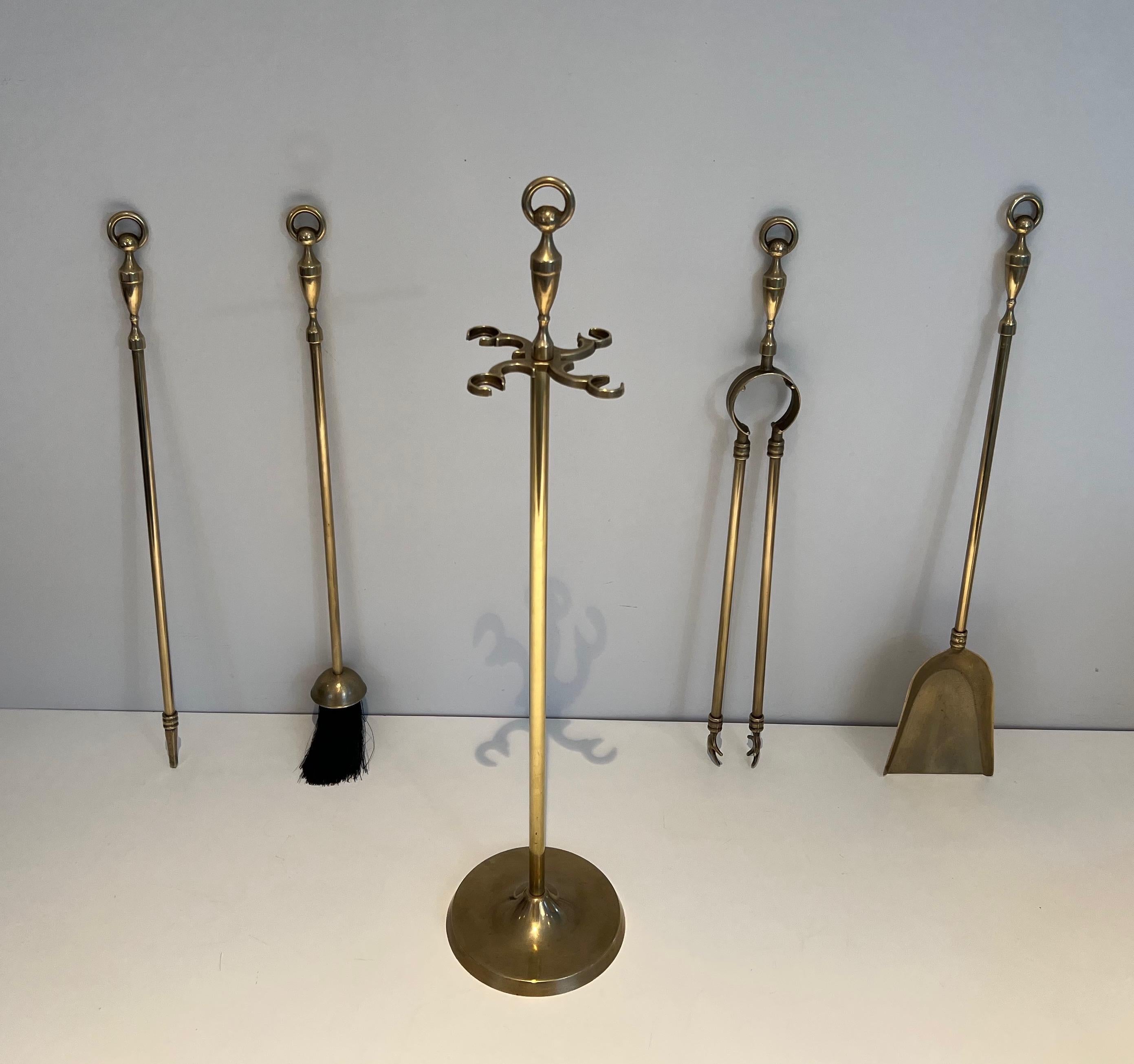 These neoclassical style fireplace tools are made of brass. This is a French work, circa 1970.