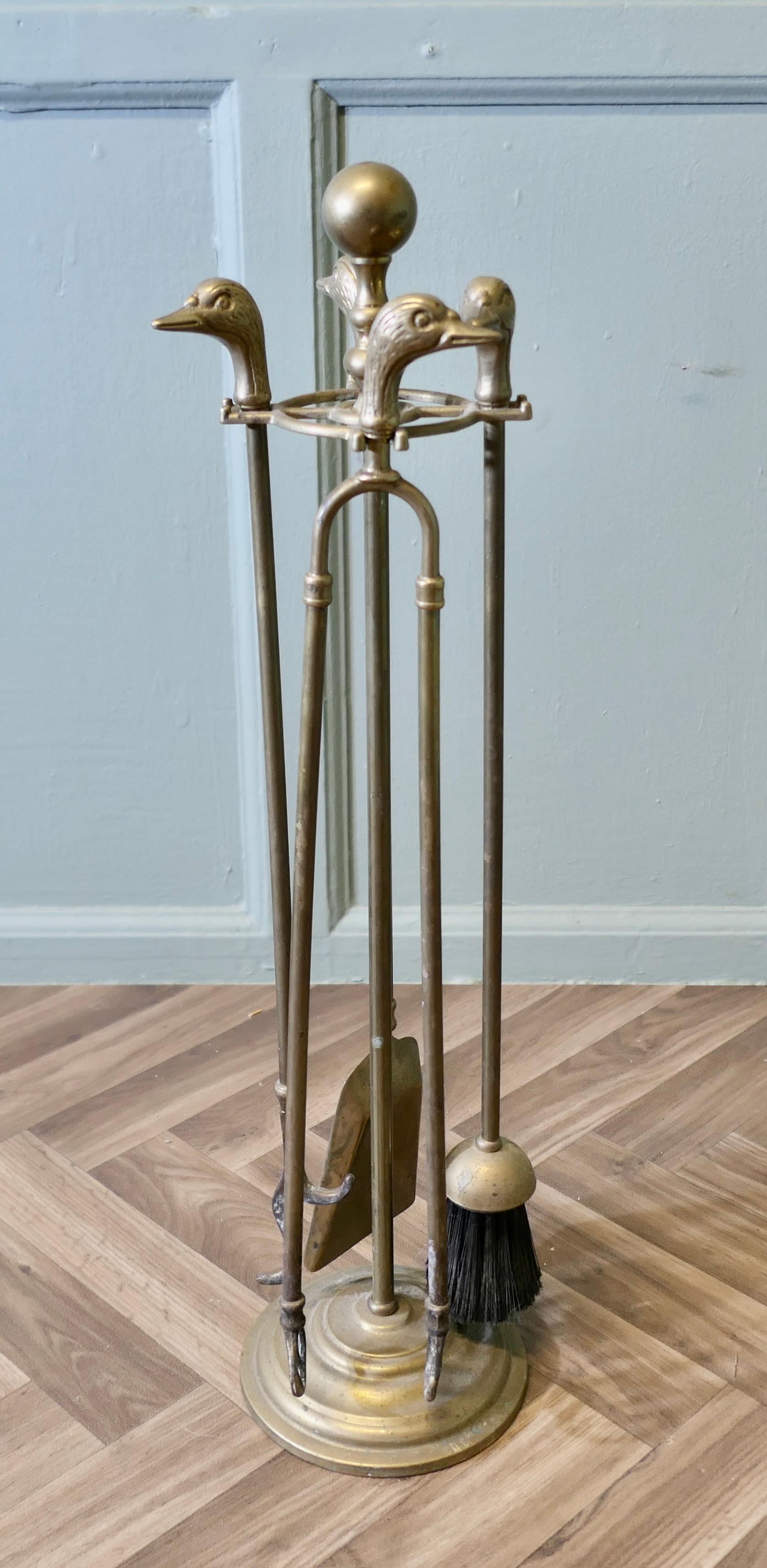 Brass Fireside Companion Set, Fireside Tools with Ducks

This is a long handled set on its own stand, shovel, tongs, brush and poker with Charming ducks on the end
The stand 27” tall and 6” in diameter
HW144