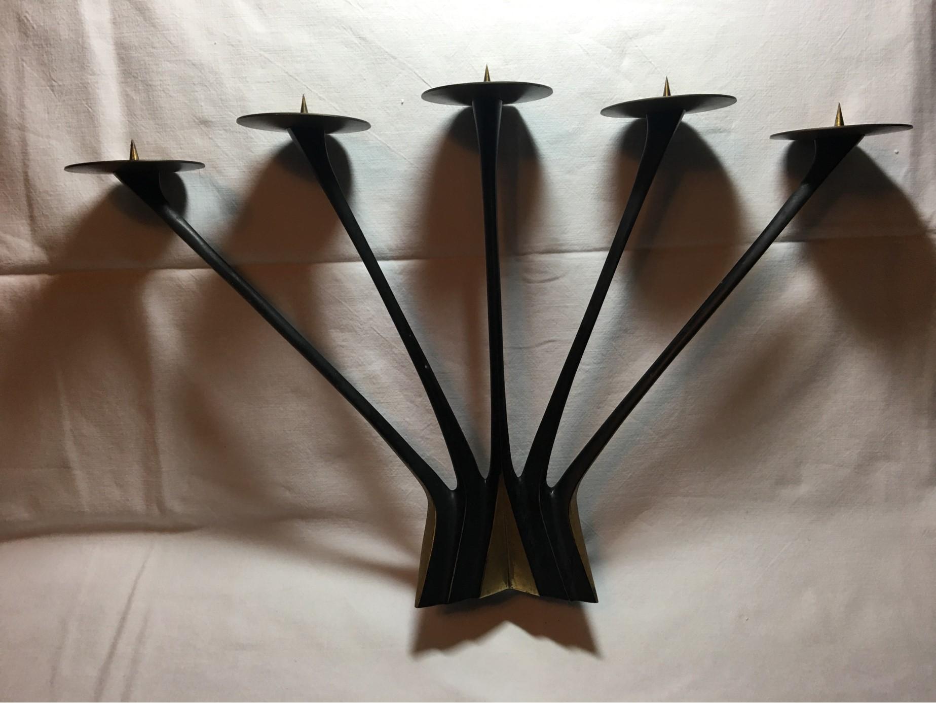 Lovely, majestic five-armed candleholder designed by Klaus Ullrich for Faber & Schumacher in the 1950s. It is made from solid metal in beautiful tones of black and brass. This German candleholder is a lovely addition to any home.