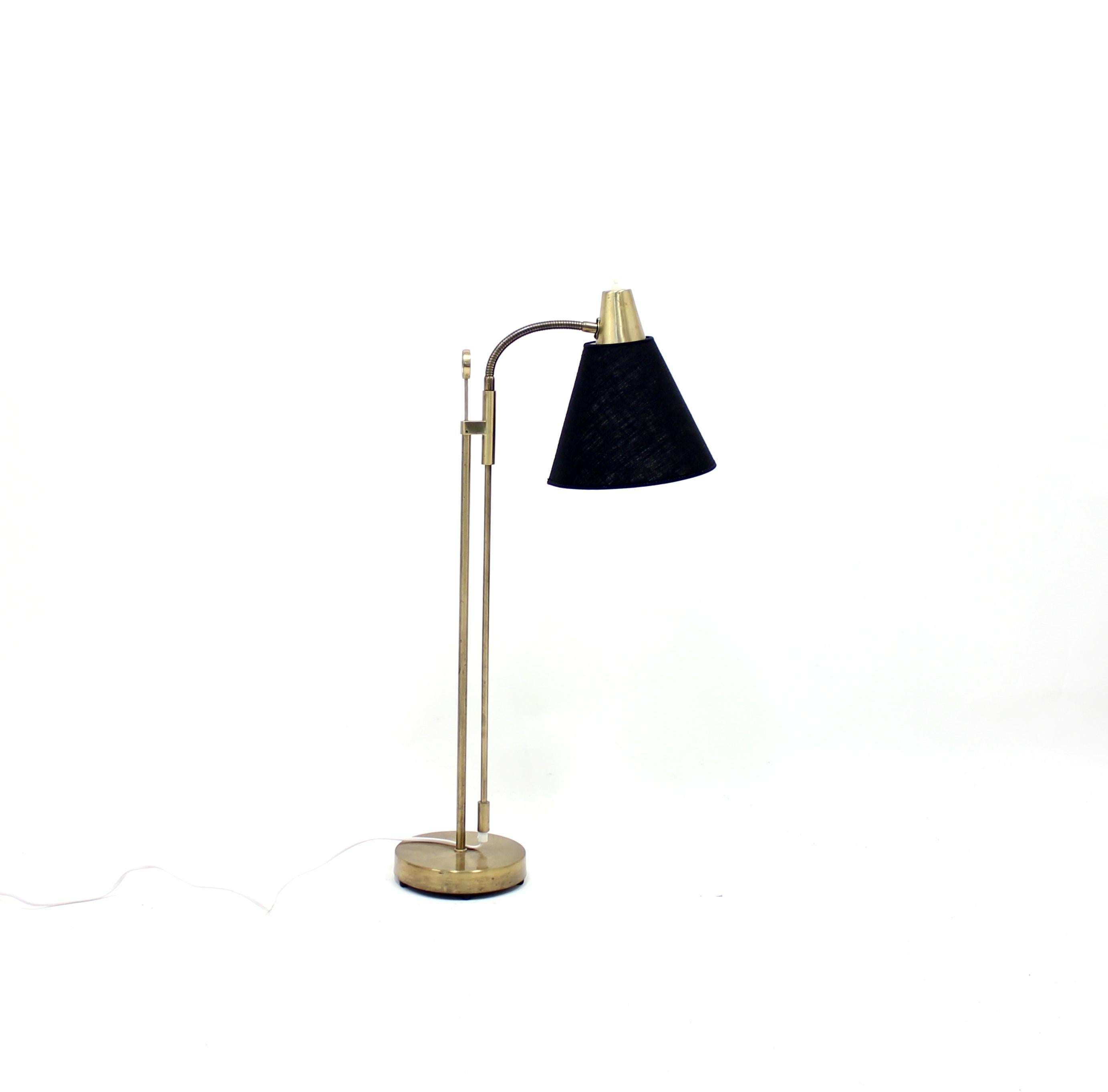 Midcentury floor lamp from Swedish manufacturer Falkenbergs Belysning. Height adjustable between 84 - 132 cm. Brass base and stem with new black fabric shade and new plug. Marked with makers mark under the base. Good vintage condition with ware