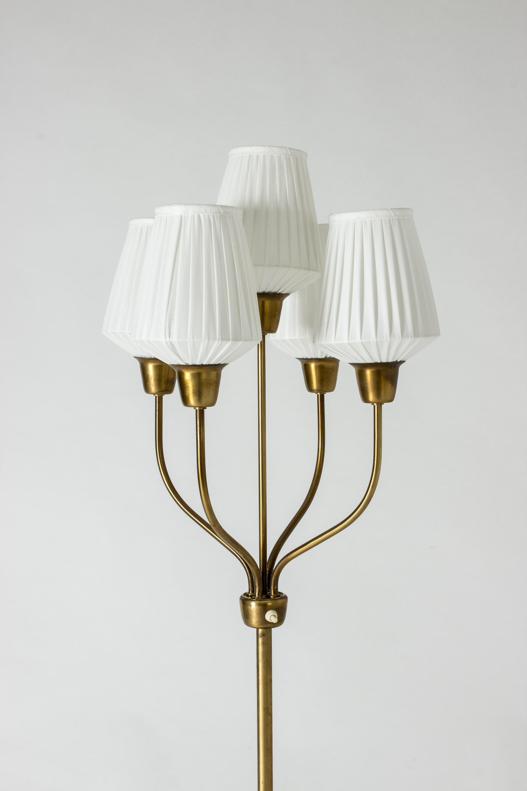 Elegant brass floor lamp by Hans Bergström with five shades on graceful arms.