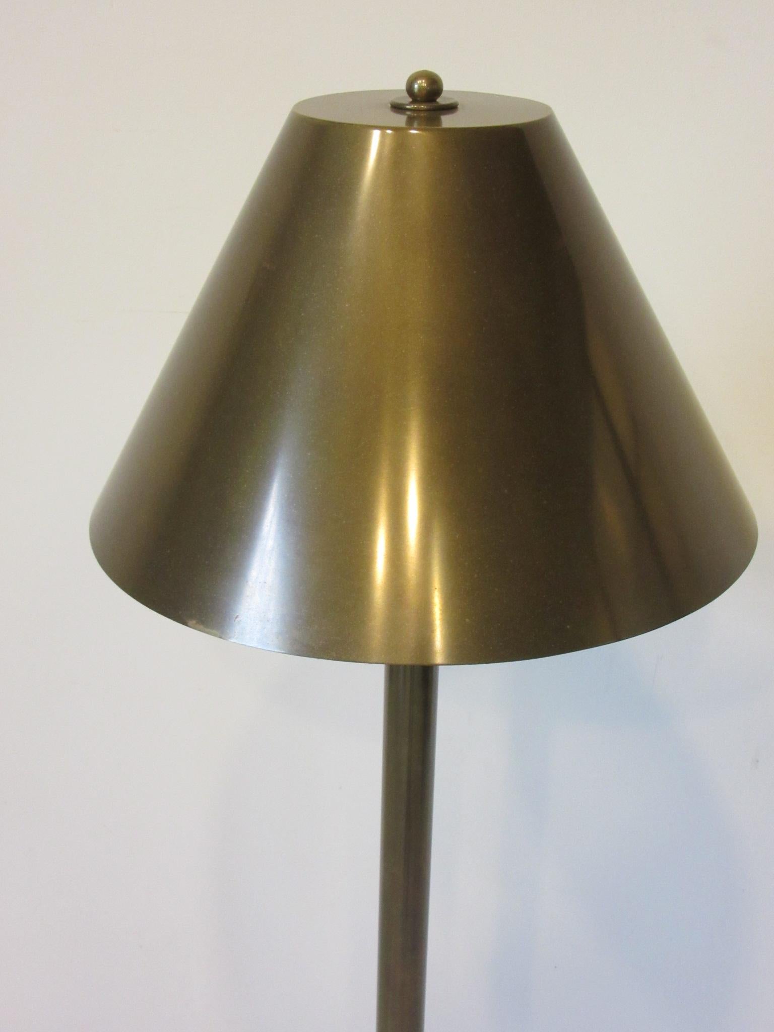 A very well crafted brass floor lamp with hand soldered shade and heavy base attributed to the fine lighting manufacturer of Chapman Studios. The real beauty of this lamp other than quality is that the design will fit in many styles of interiors and