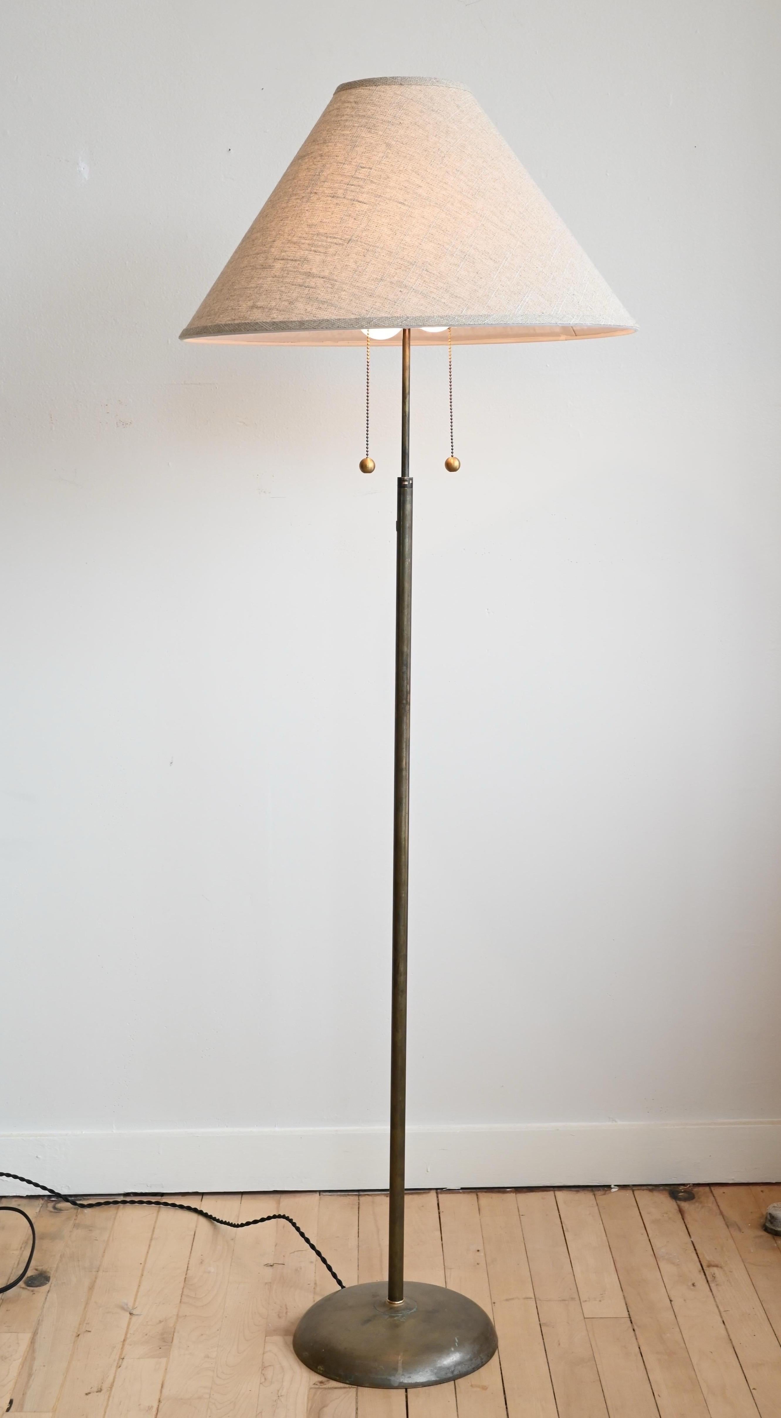 A brass & copper floor lamp with a beautiful patina on the body and base. Textured linen contemporary shade.