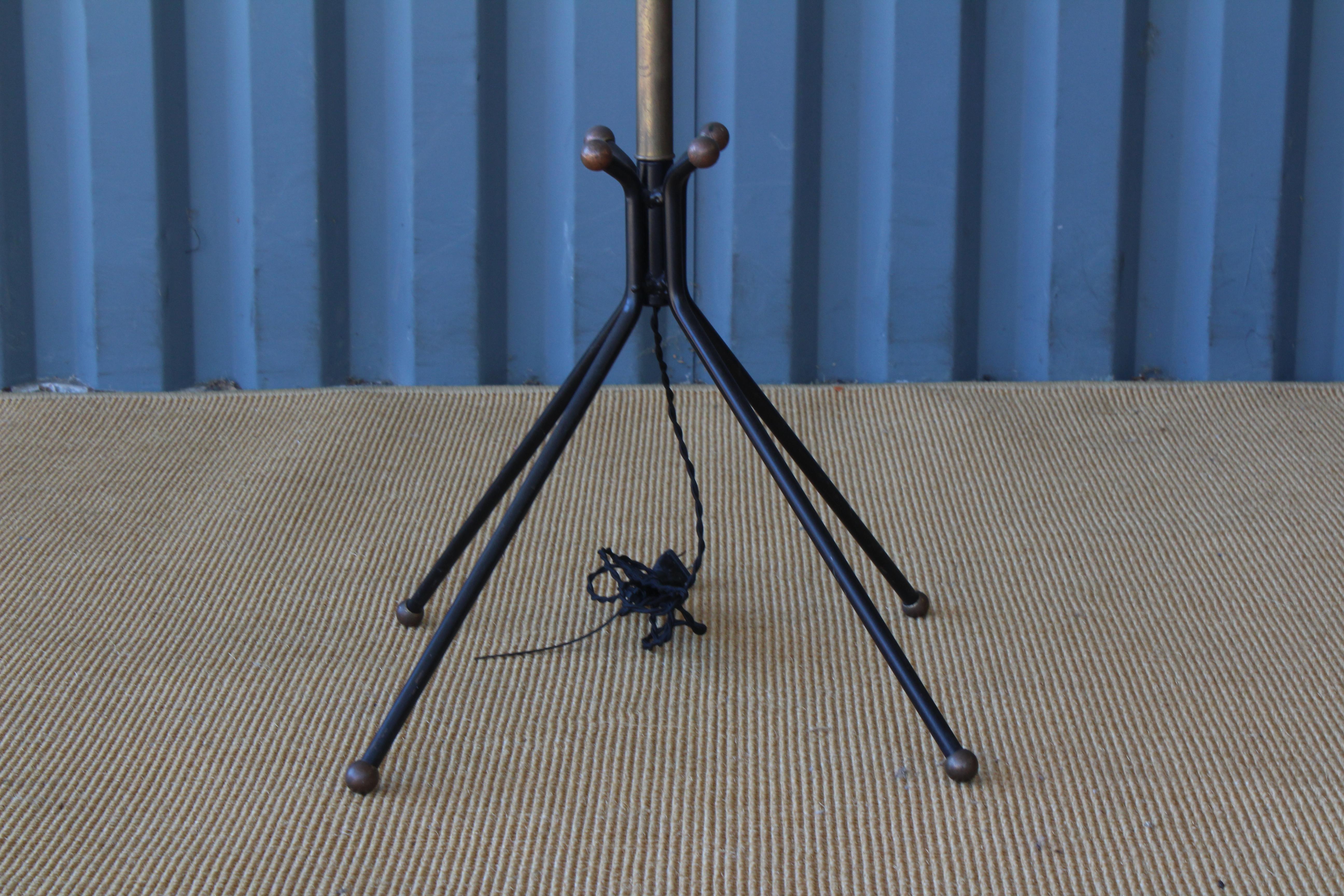 1960s Italian floor lamp with a brass stem and four legged metal base. Legs feature ball capped feet. Newly rewired and fitted with a custom-made shade in off-white linen.