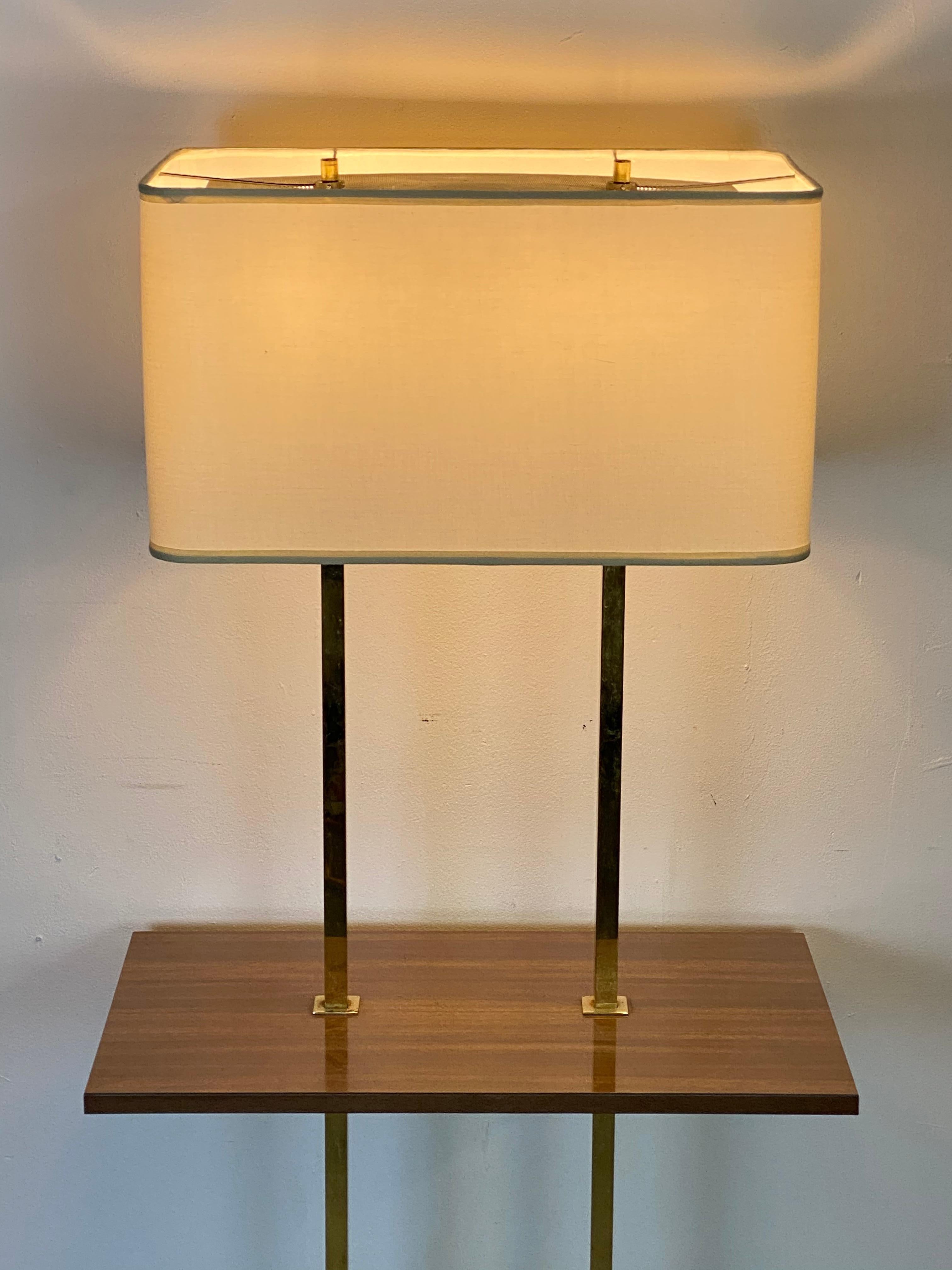 Elegant brass floor lamp in the manner of Stiffel. Rectangular tray provides the perfect place for your martini. New custom lampshade with original finials and perforated sheet atop. Double sockets allow for independent use and accommodate modern