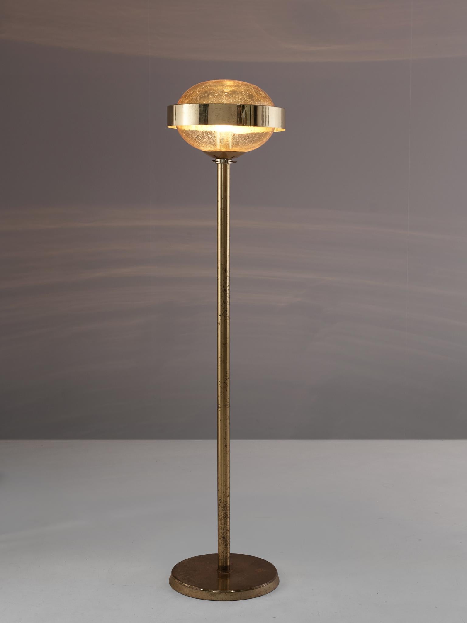 Floorlamps, in brass and glass, European 1970s.

Elegant floorlamp with brass frame and raindrop-glass sphere. The light has a nice round brass base, cylindrical stern and glass sphere with brass ring. Due the combination of material these lights